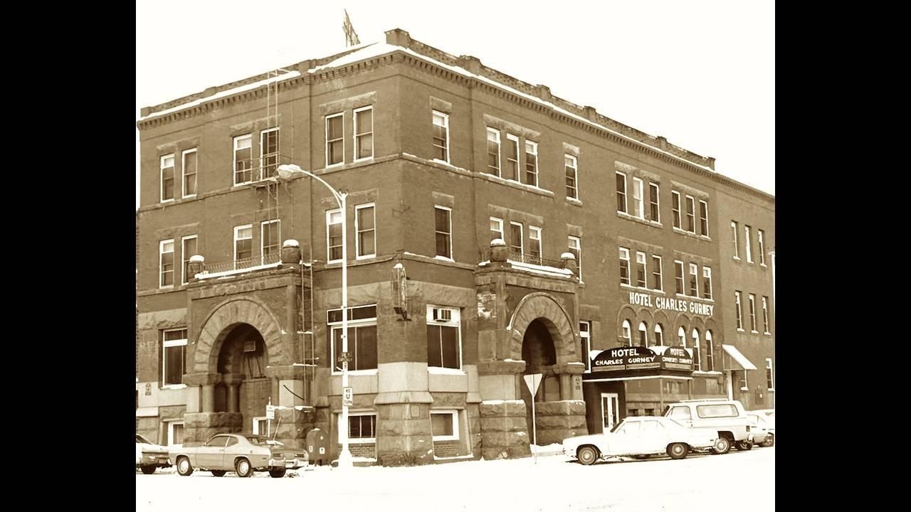 Archival photo of a large four story building. 
