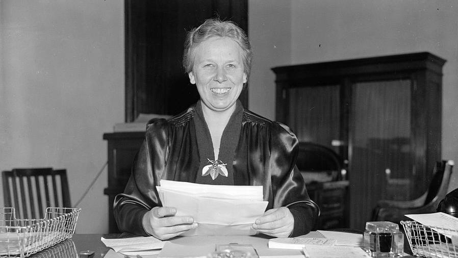 Gladys Pyle sitting at a desk. 