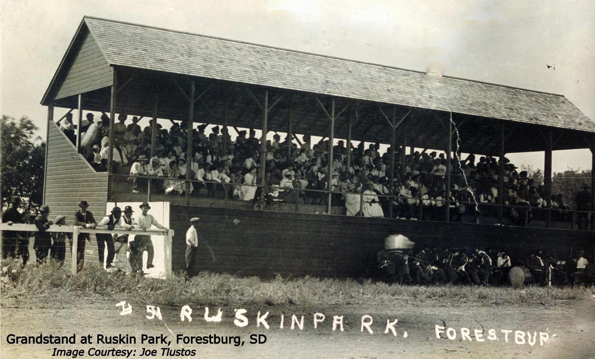 Archival photo of a grandstand full of spectators. 
