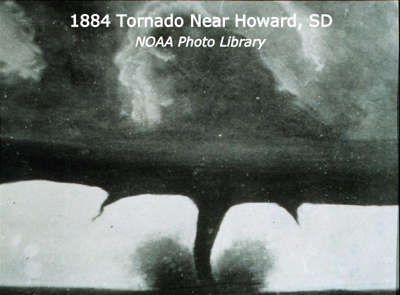 1884 tornado near Howard, SD. Dark clouds with one main tornado touching the ground blowing up debris with two smaller tornados on each side that are not touching the ground.  