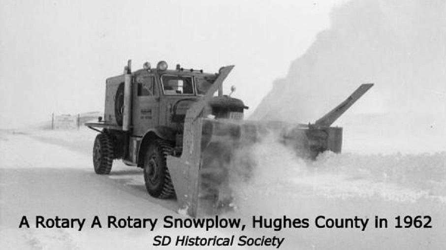 Archival photo of a military show plow blowing snow. 