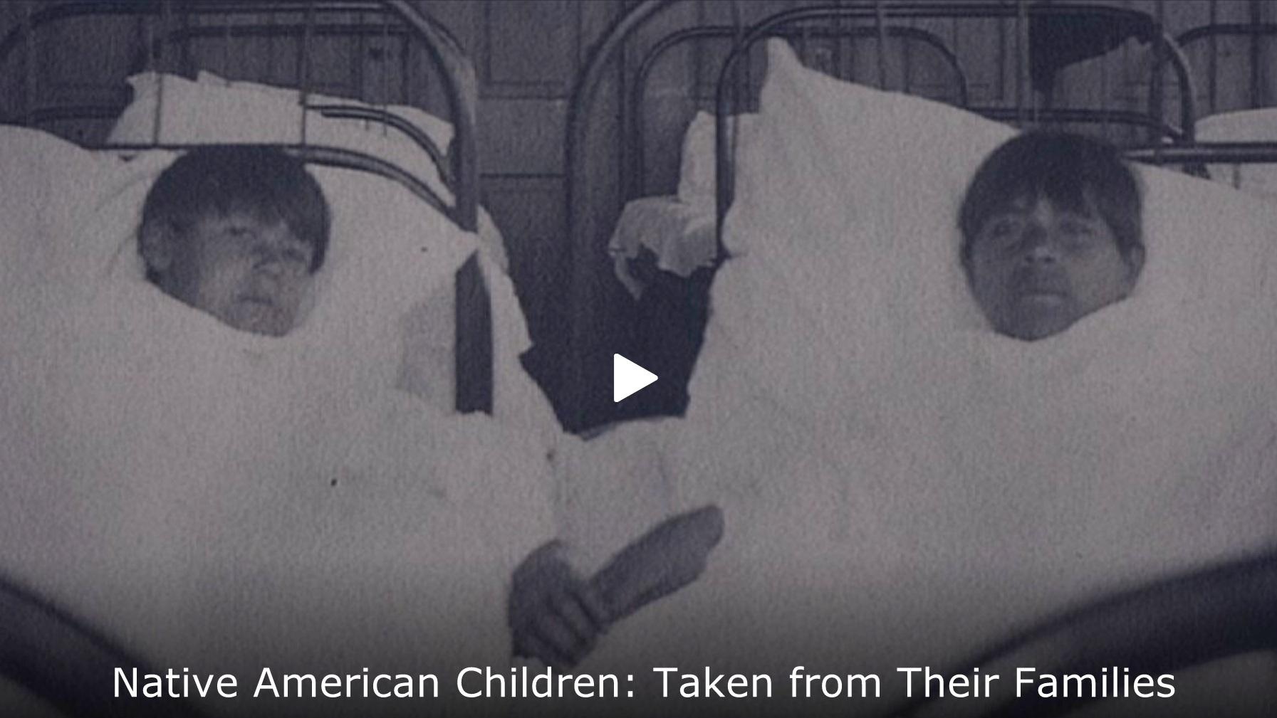 Archival photo of two Native American boys laying in hospital beds. 