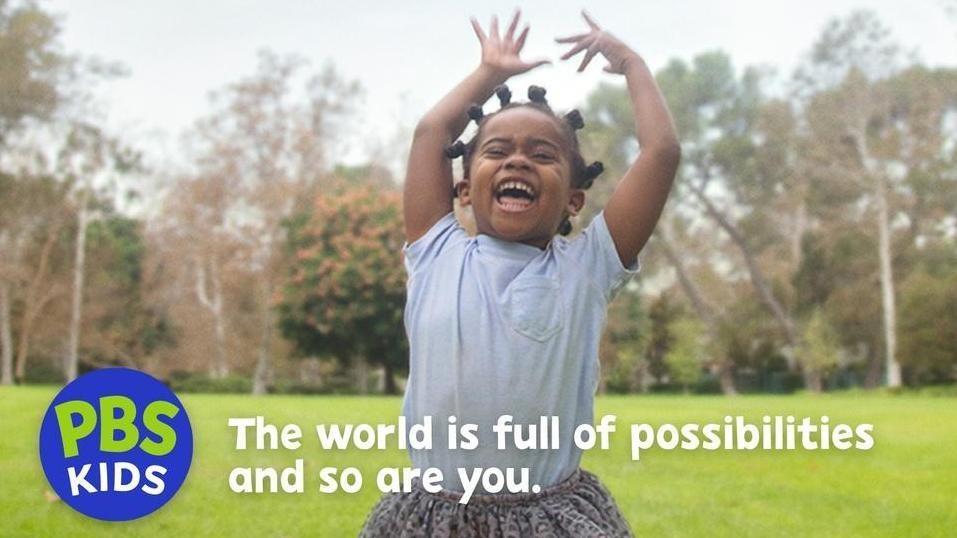 A young child is outside laughing with their hands in the air. Text on image says PBS KIDS The world is full of possibilities and so are you. 
