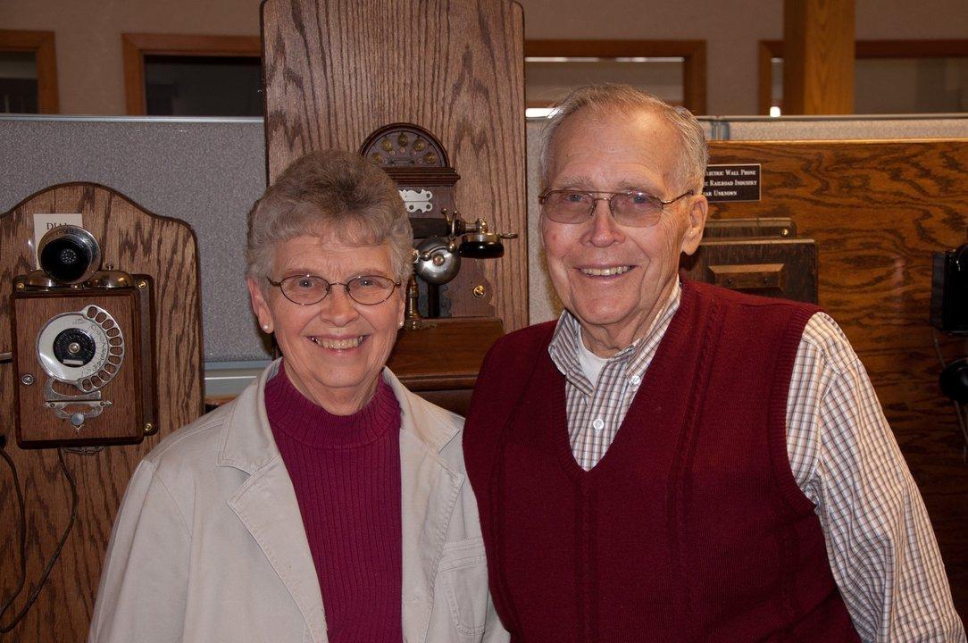 Peg and Frank Gebhardt with their phone collection at the Alamon offices in Kalispell