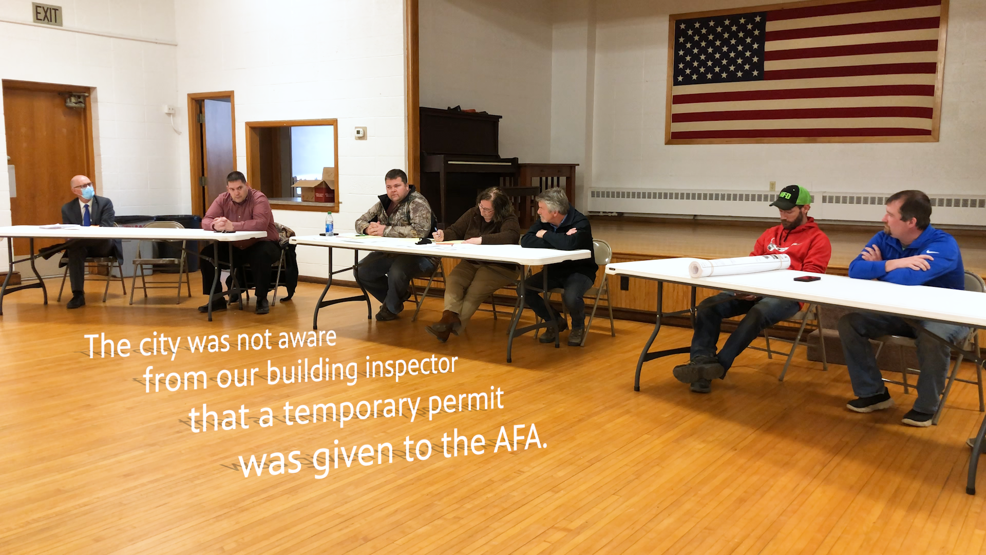 A photo of the Murdock City Council during their April meeting with text that says, "The city was not aware from our building inspector that a temporary permit was given to the AFA."