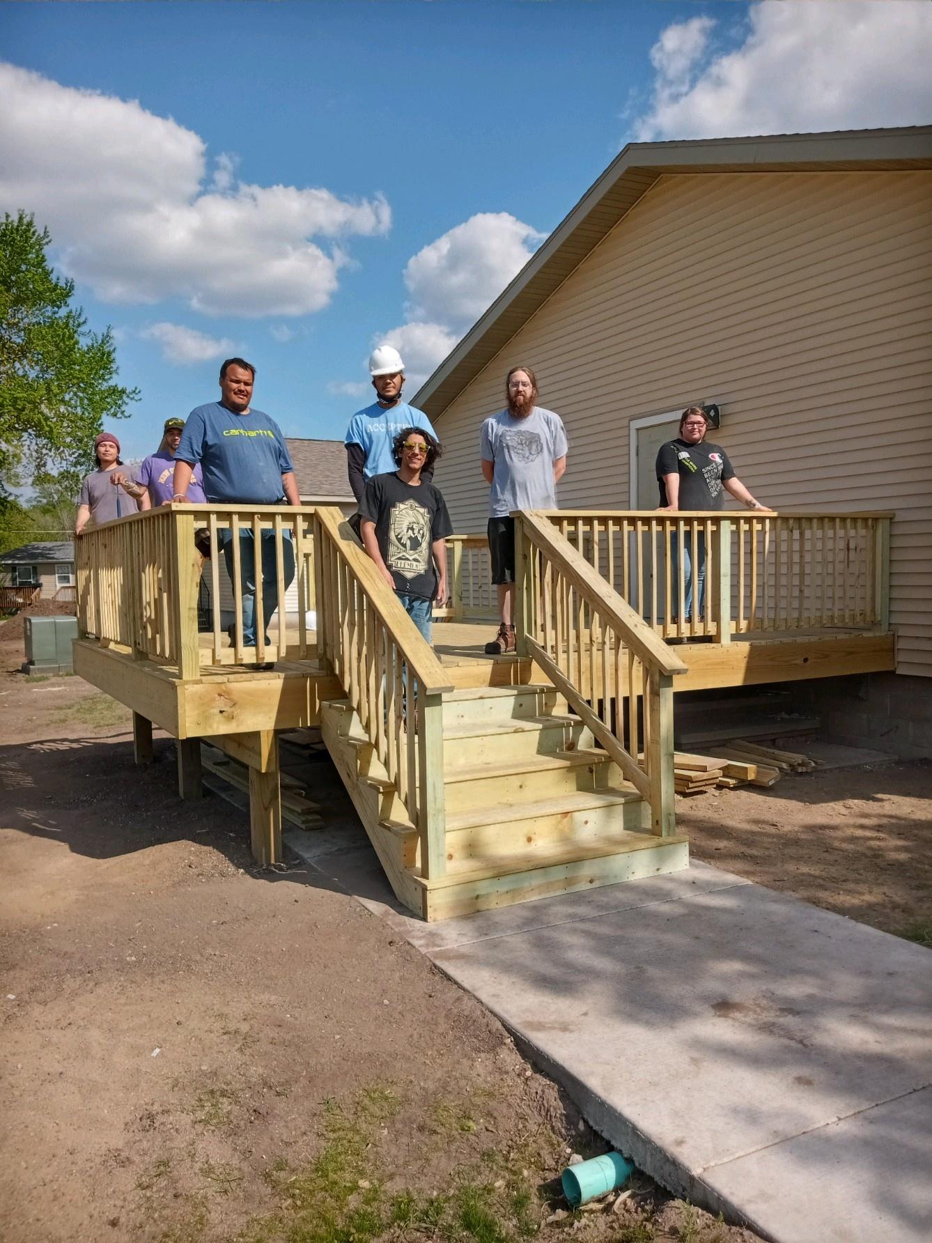 Students of the Cankuya Construction Trades program in front of their finished deck.