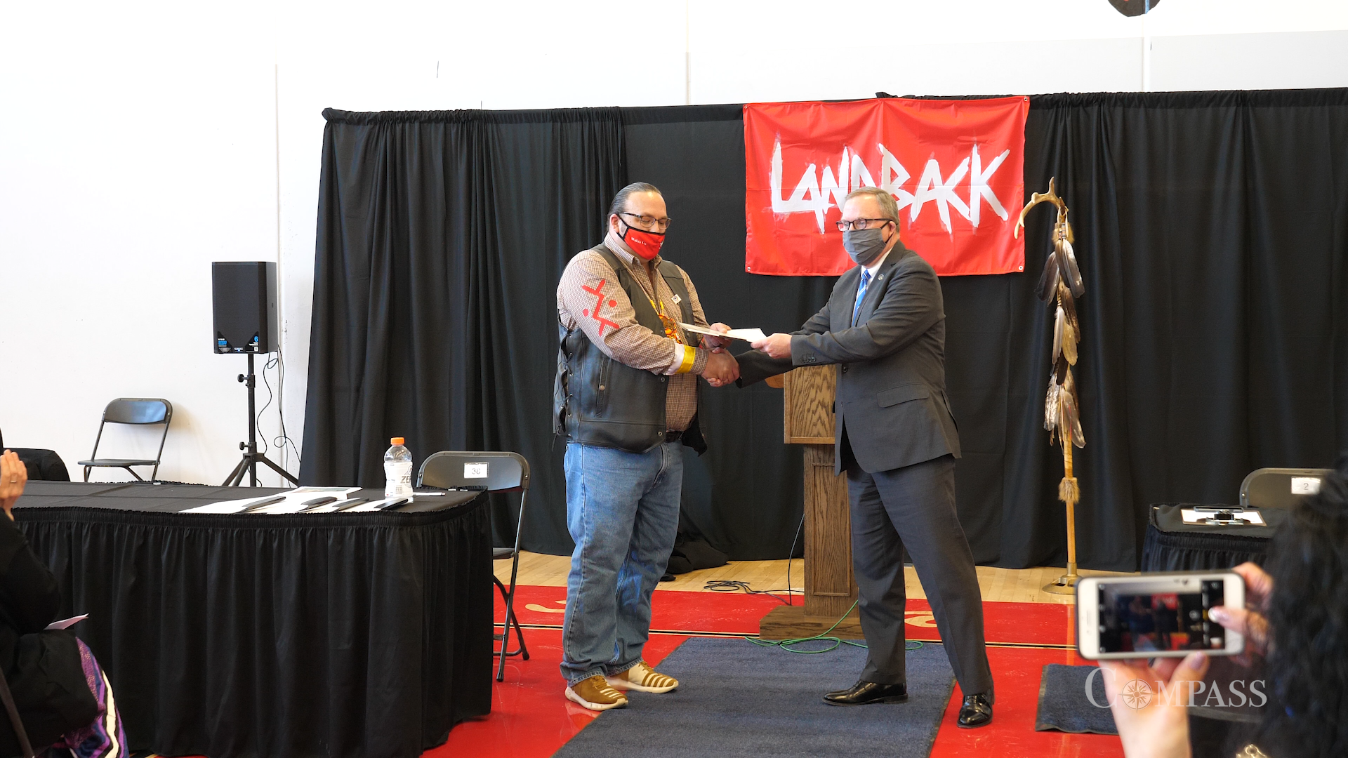 Lower Sioux Chairman Robert Larsen shakes hand with the Minnesota Historical Society's executive director. 