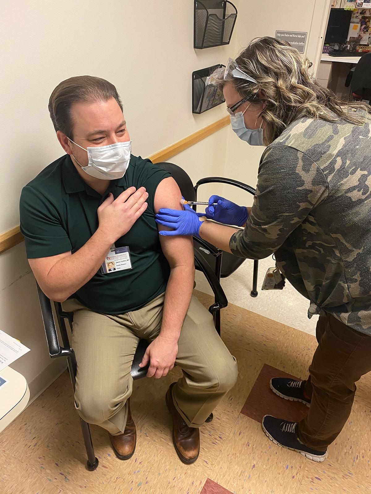 Dr. Huicco getting a COVID-19 vaccine
