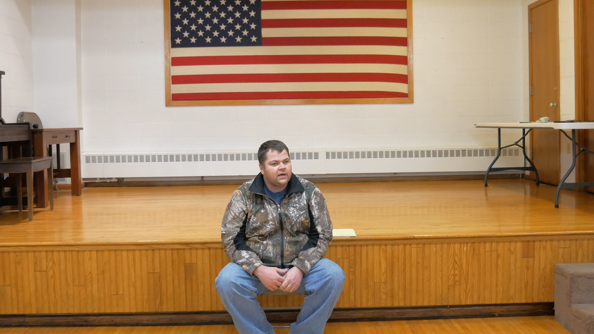 An image of Murdock Mayor Craig Kavanagh sitting in City Hall in front of a USA flag.
