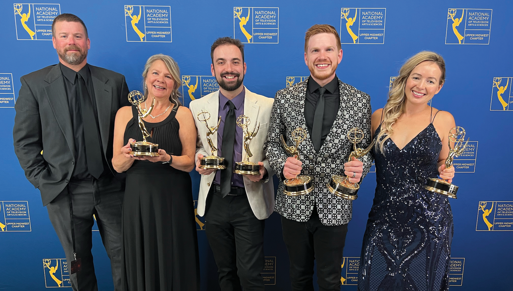 Prairie Sportsman and Postcards crews holding Emmys