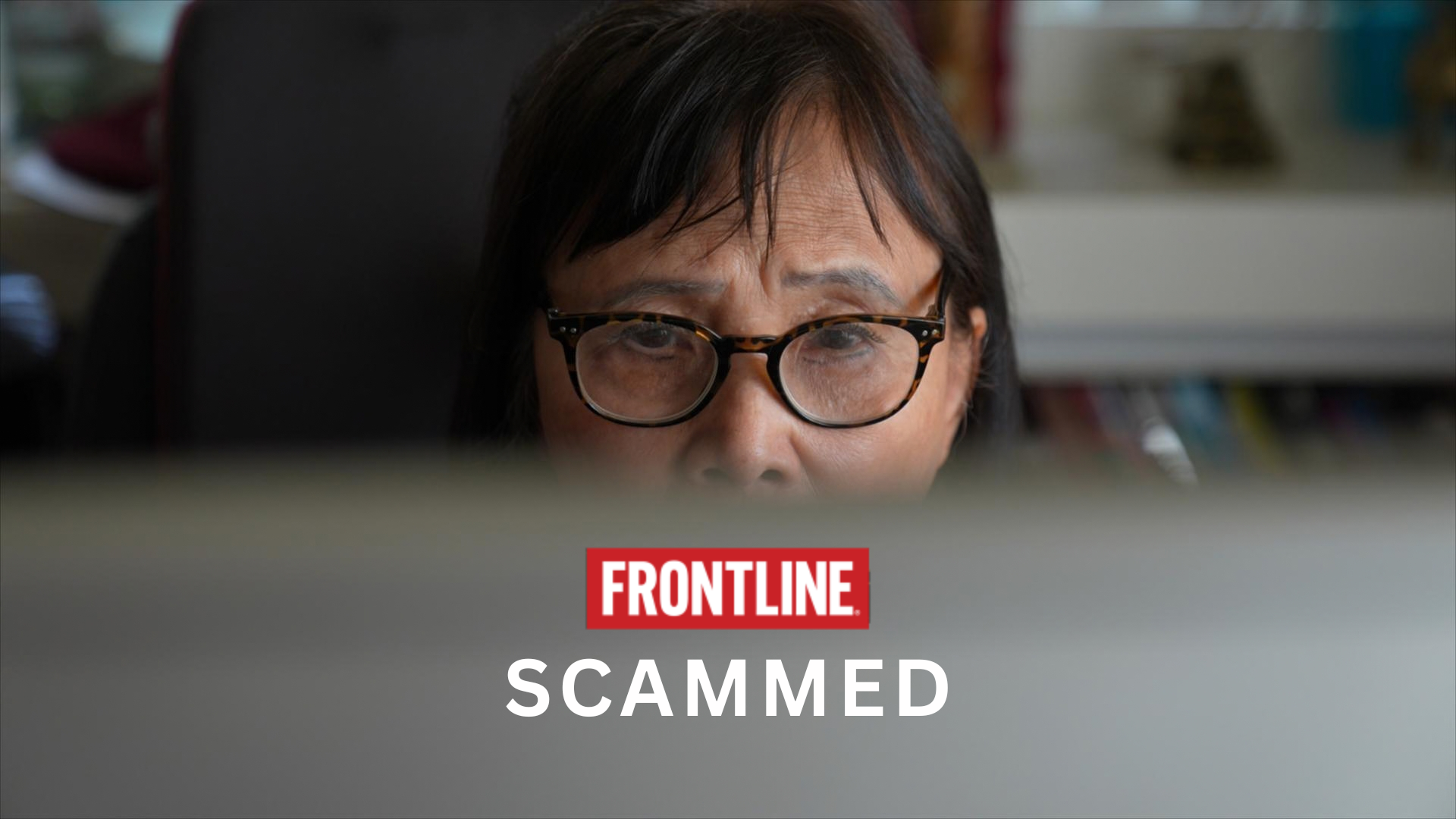 Image shows a woman staring intently at a computer screen. the title of the program is frontline scammed.