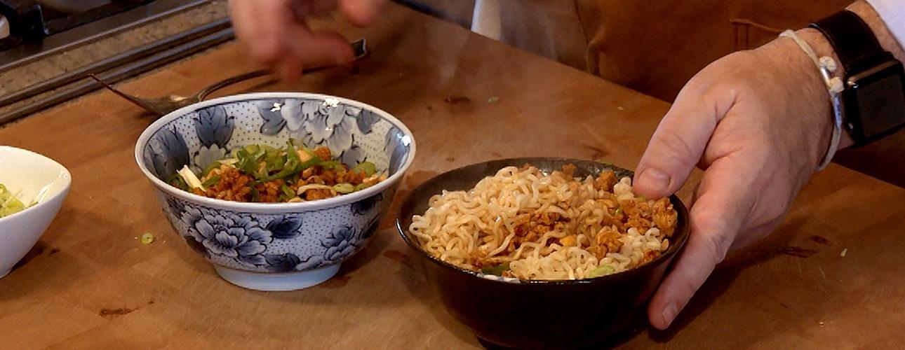 Curly noodles in a bowl with toppings
