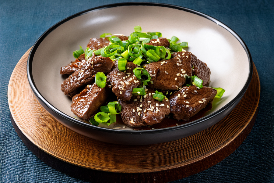 mongolian beef dish with green onions and toasted sesame seeds