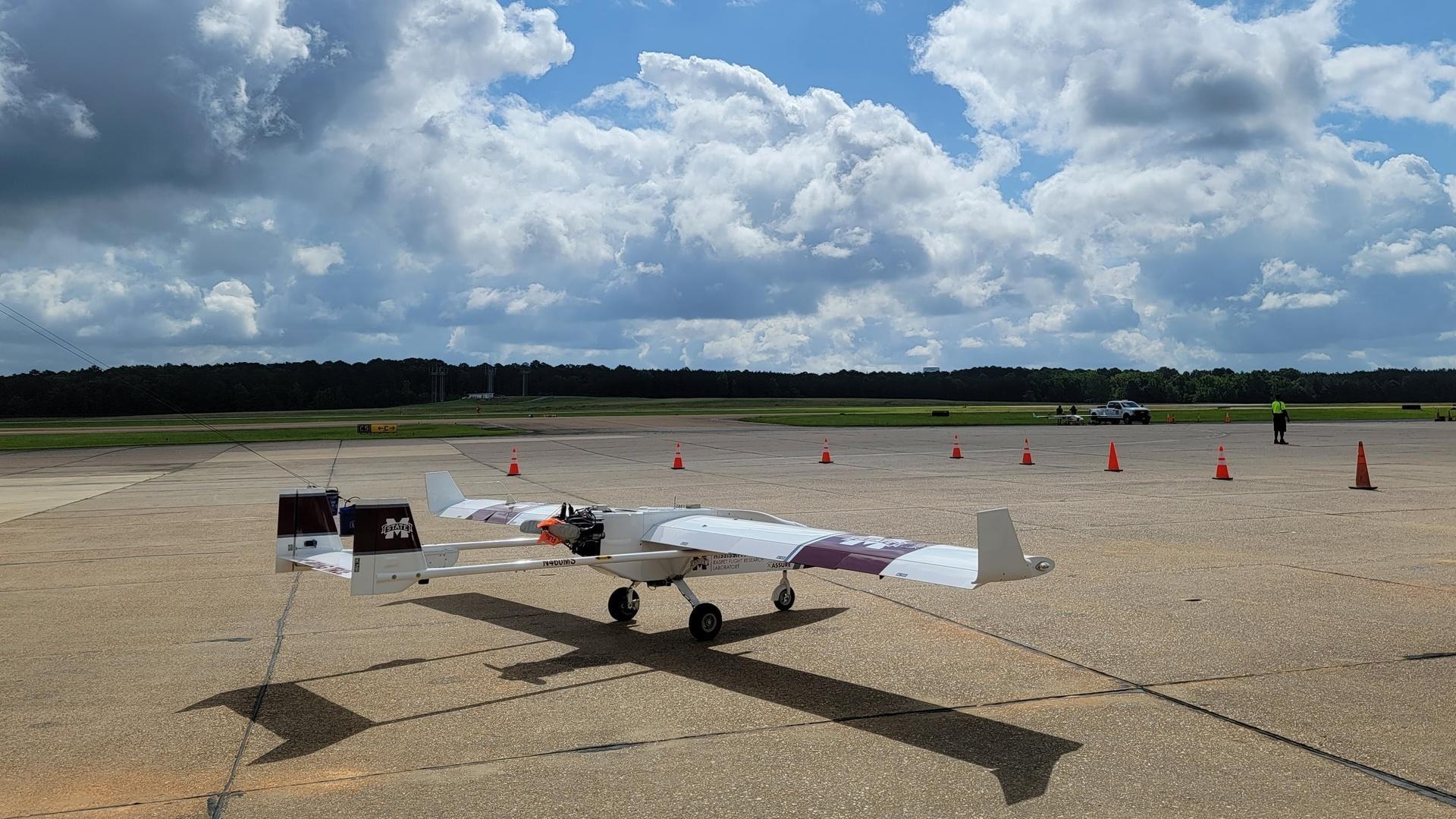 An unmanned aircraft sits on an airport's tarmac.