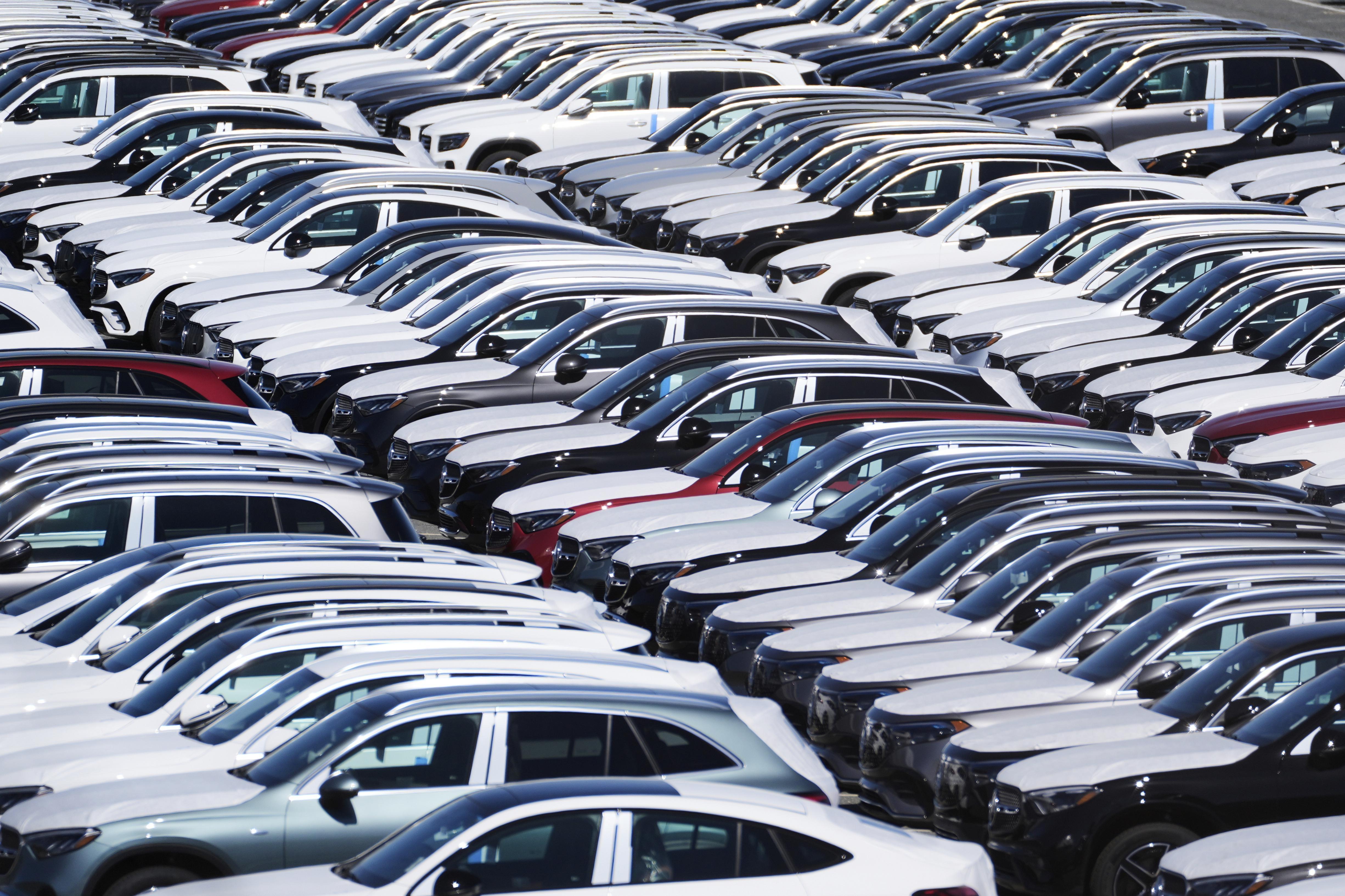 Rows of new Mercedes-Benz vehicles are shown.