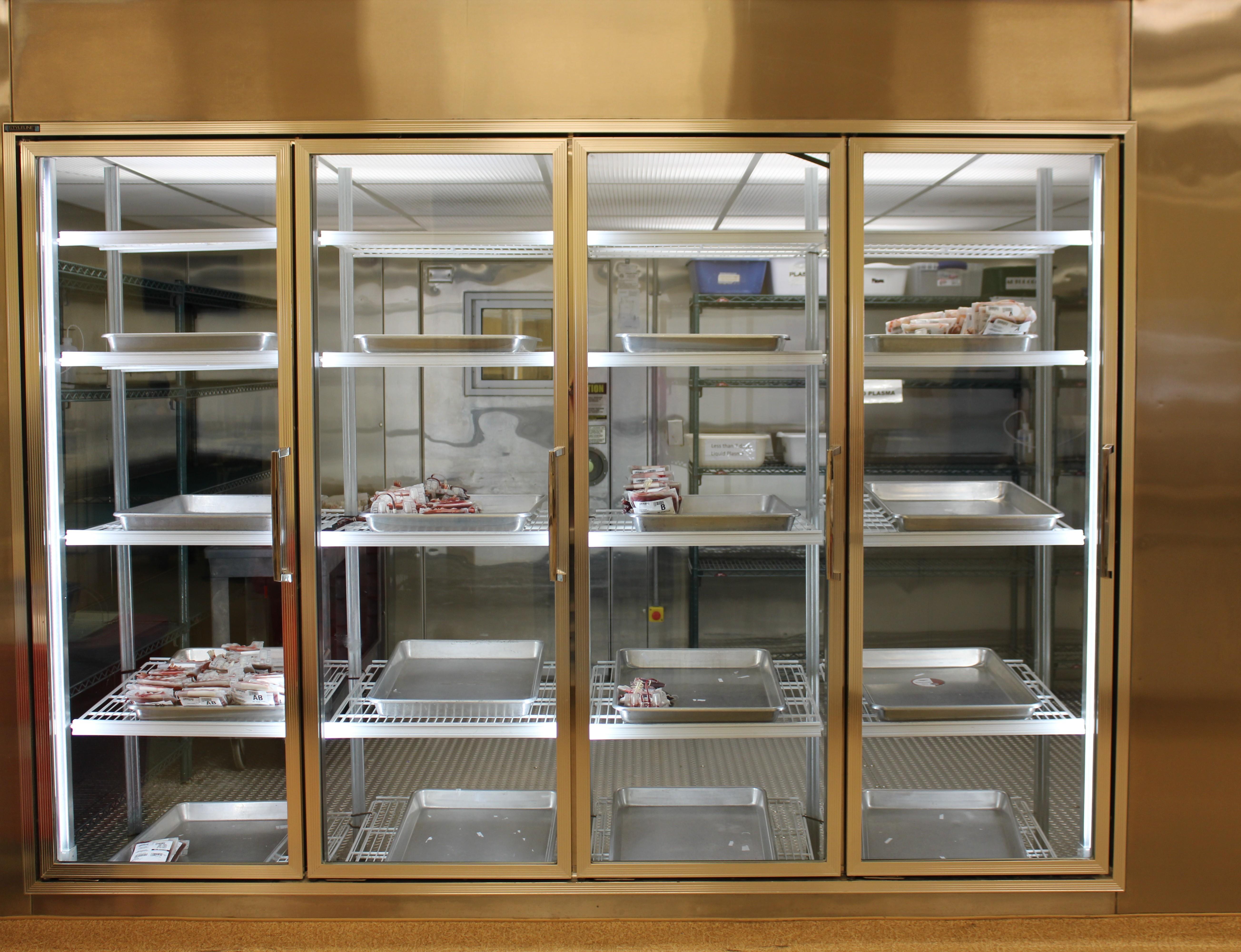 A nearly empty blood donation fridge is seen.