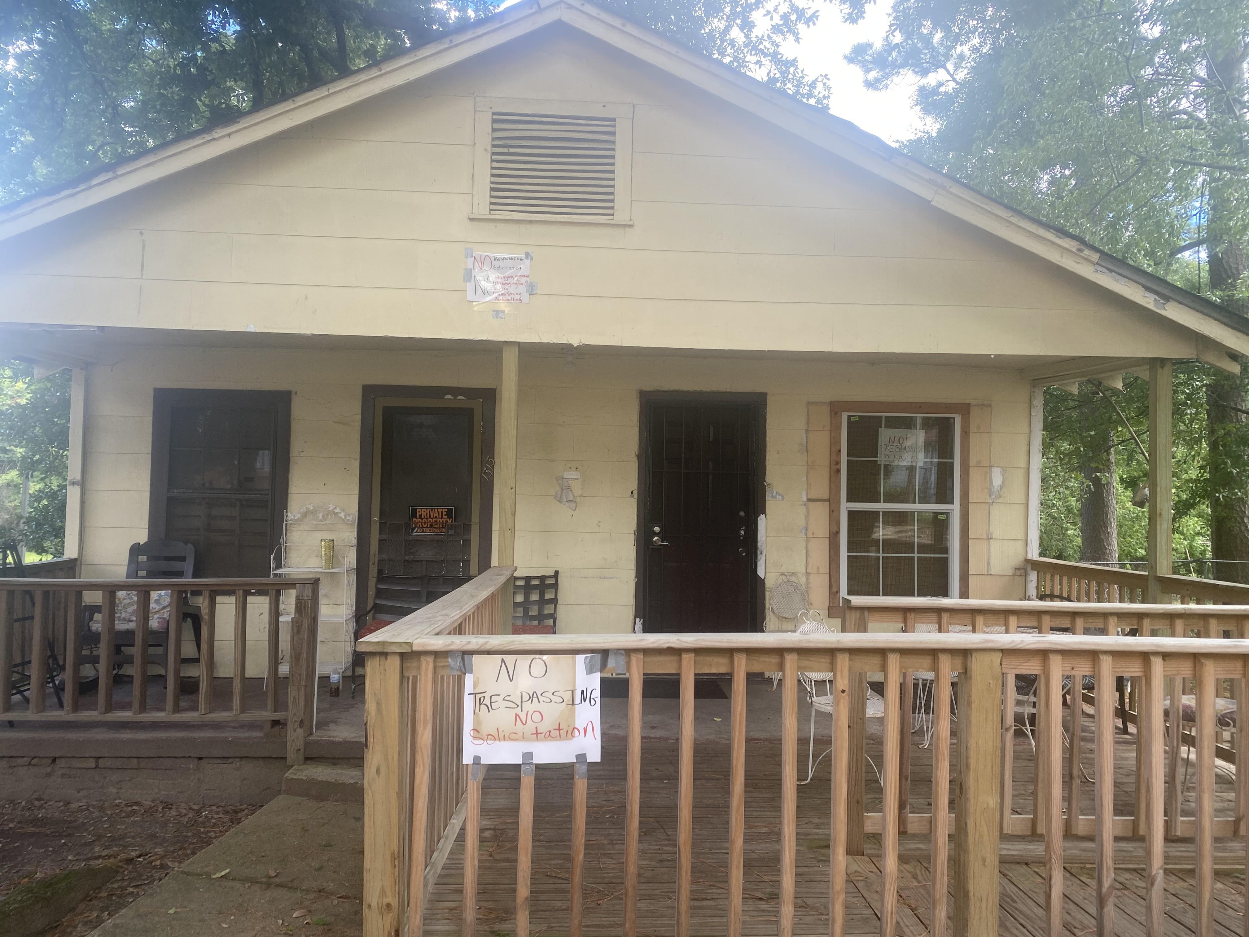 A house with several no trespassing signs.