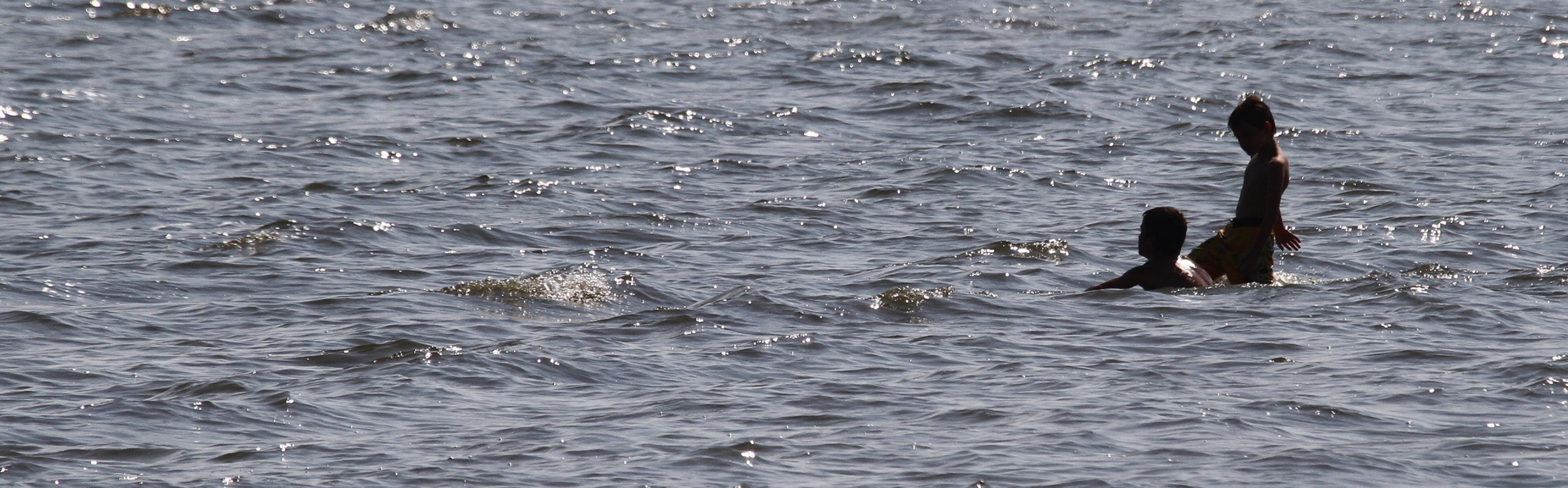Children play in the ocean. 