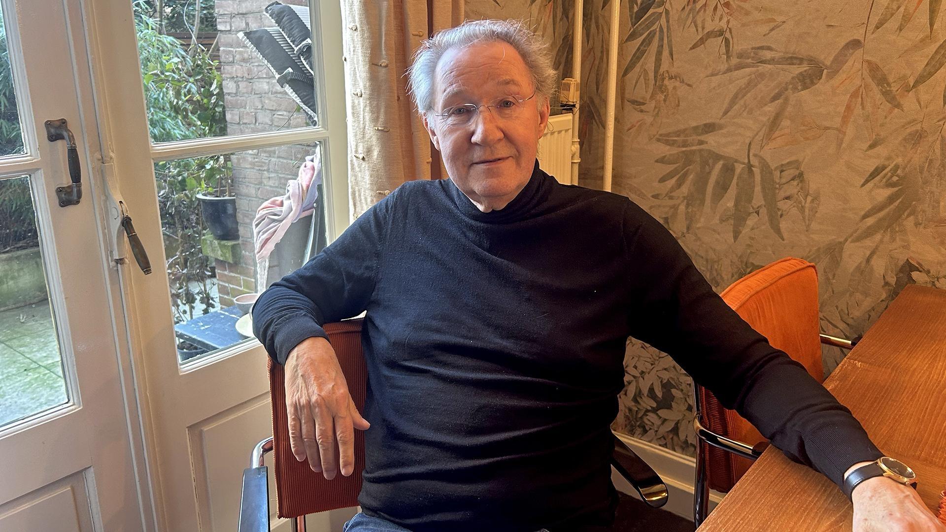 Dr. Wim van den Brink sits at his kitchen coffee table in Amsterdam on Thursday, March 13, 2025. 
