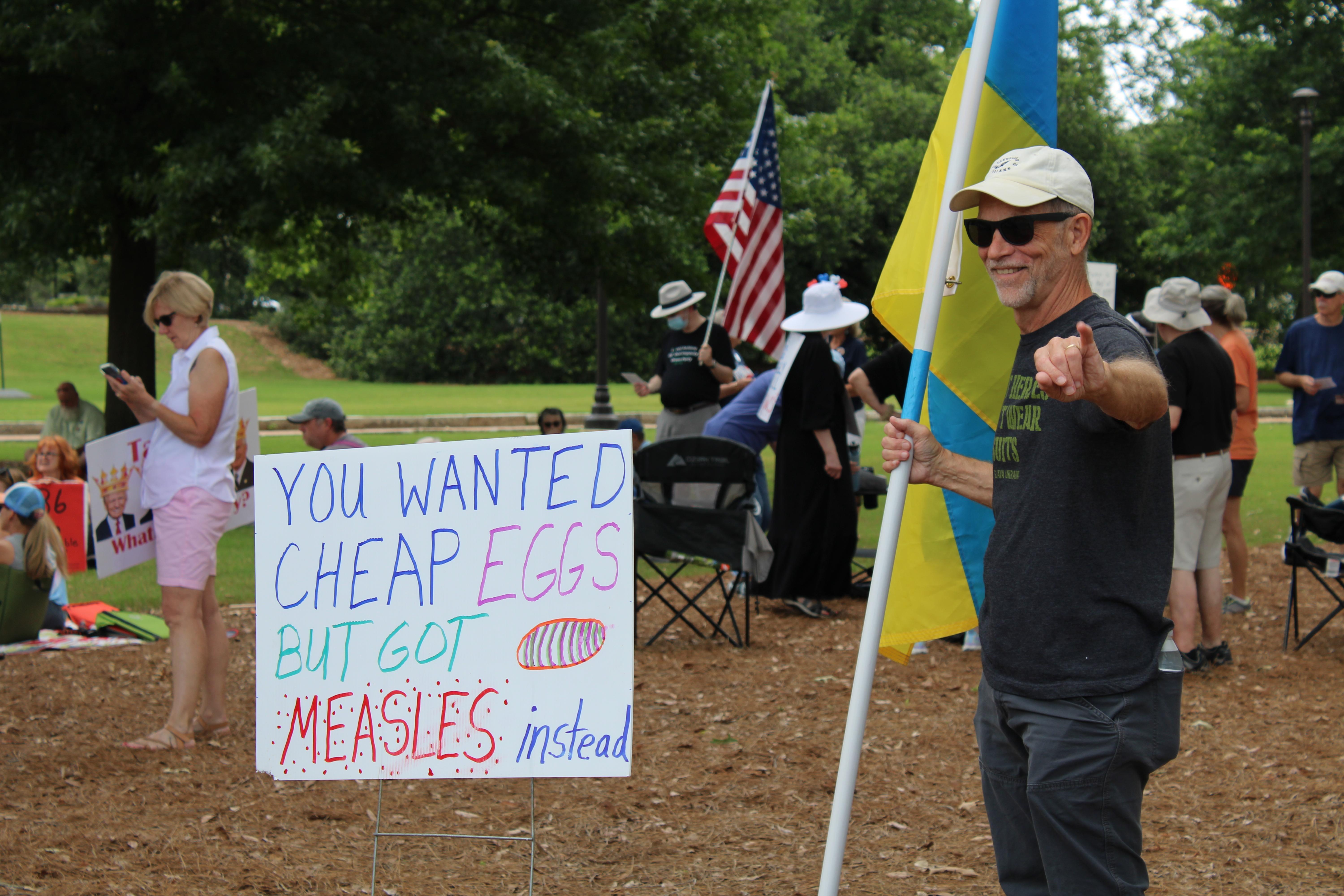 A protester stands with a Ukrainian flag during a protest Saturday at the state capitol in Jackson.