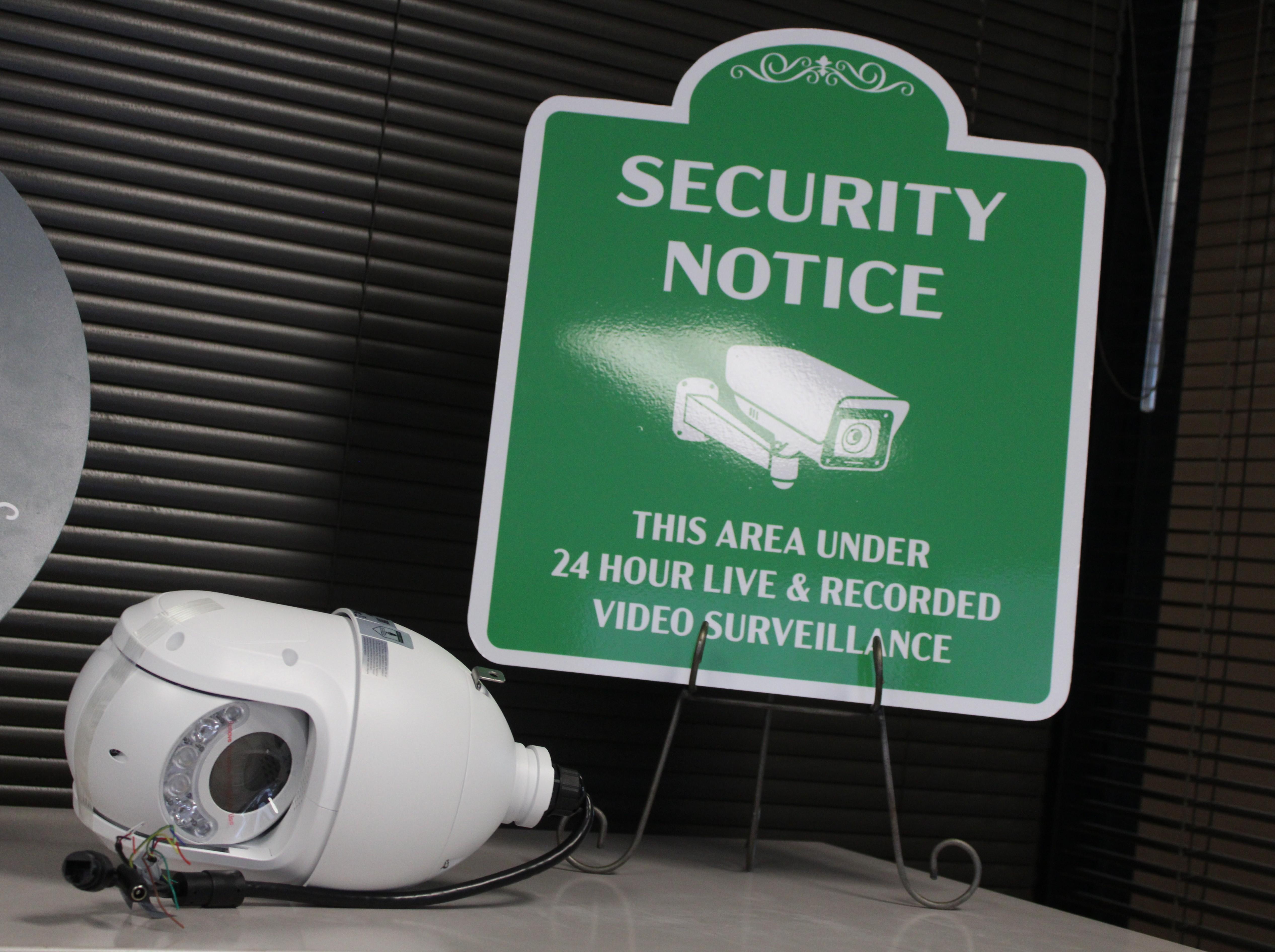 A security camera and a sign are seen at the offices of Downtown Jackson Partners.