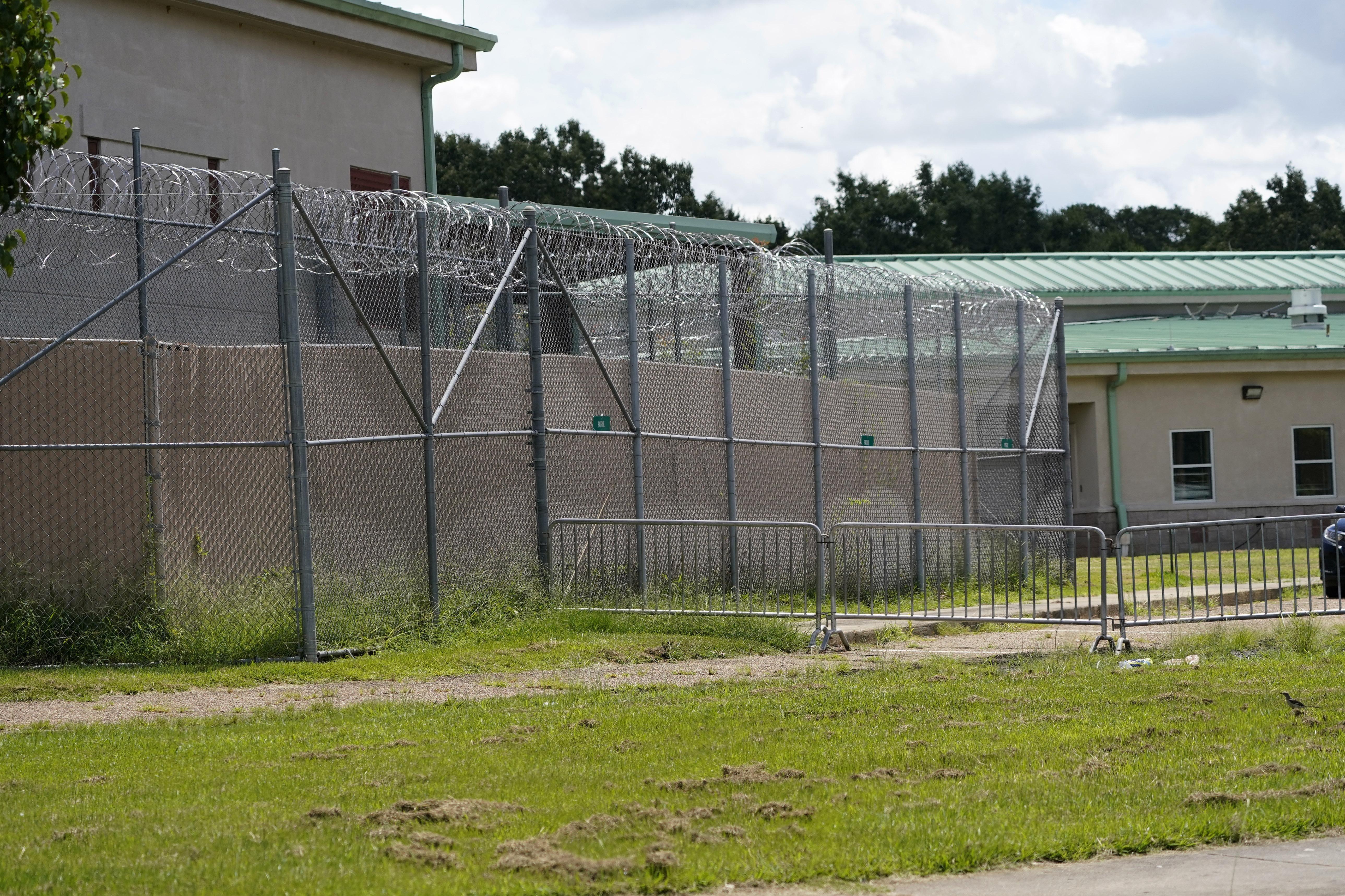Rolls of razor wire line the top of the security fencing at the Hinds County Detention Facility.