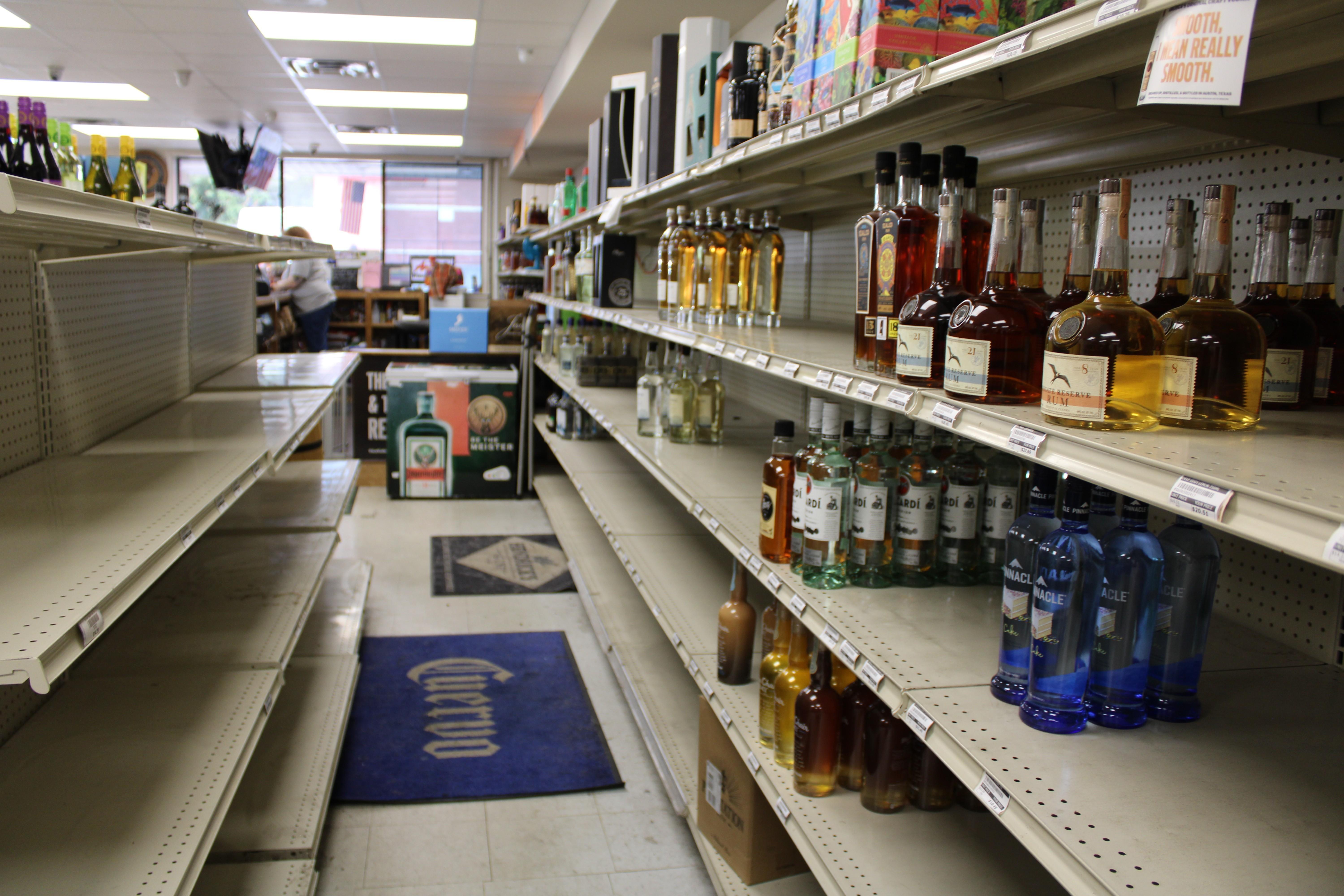 Scattered bottles of liquor sit on shelves in Arrow Wine and Spirits in Clinton, Ms.