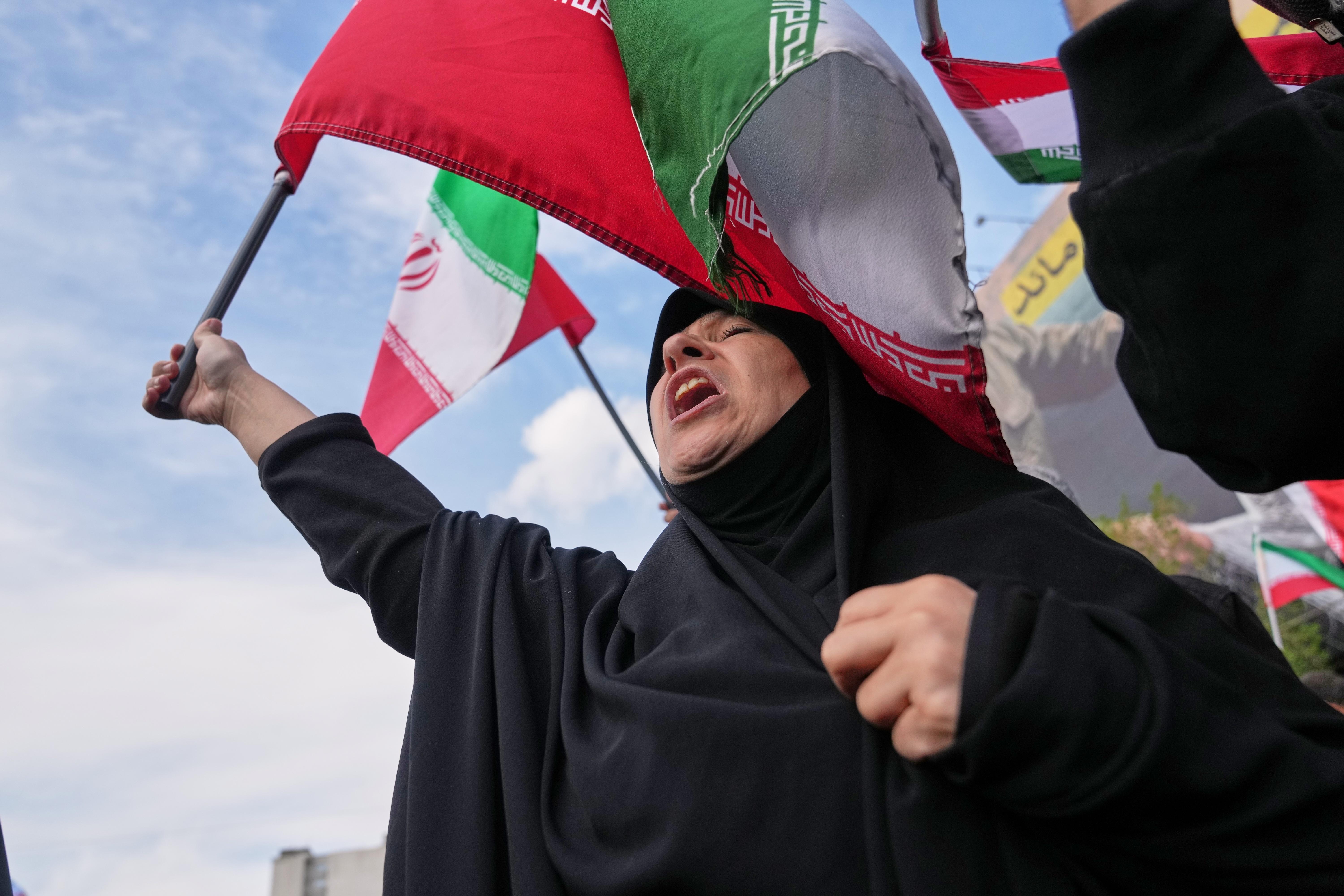 Government supporters chant slogans after the announcement of a two-week ceasefire with the United States and Israel in Tehran, Iran, Wednesday, April 8, 2026.