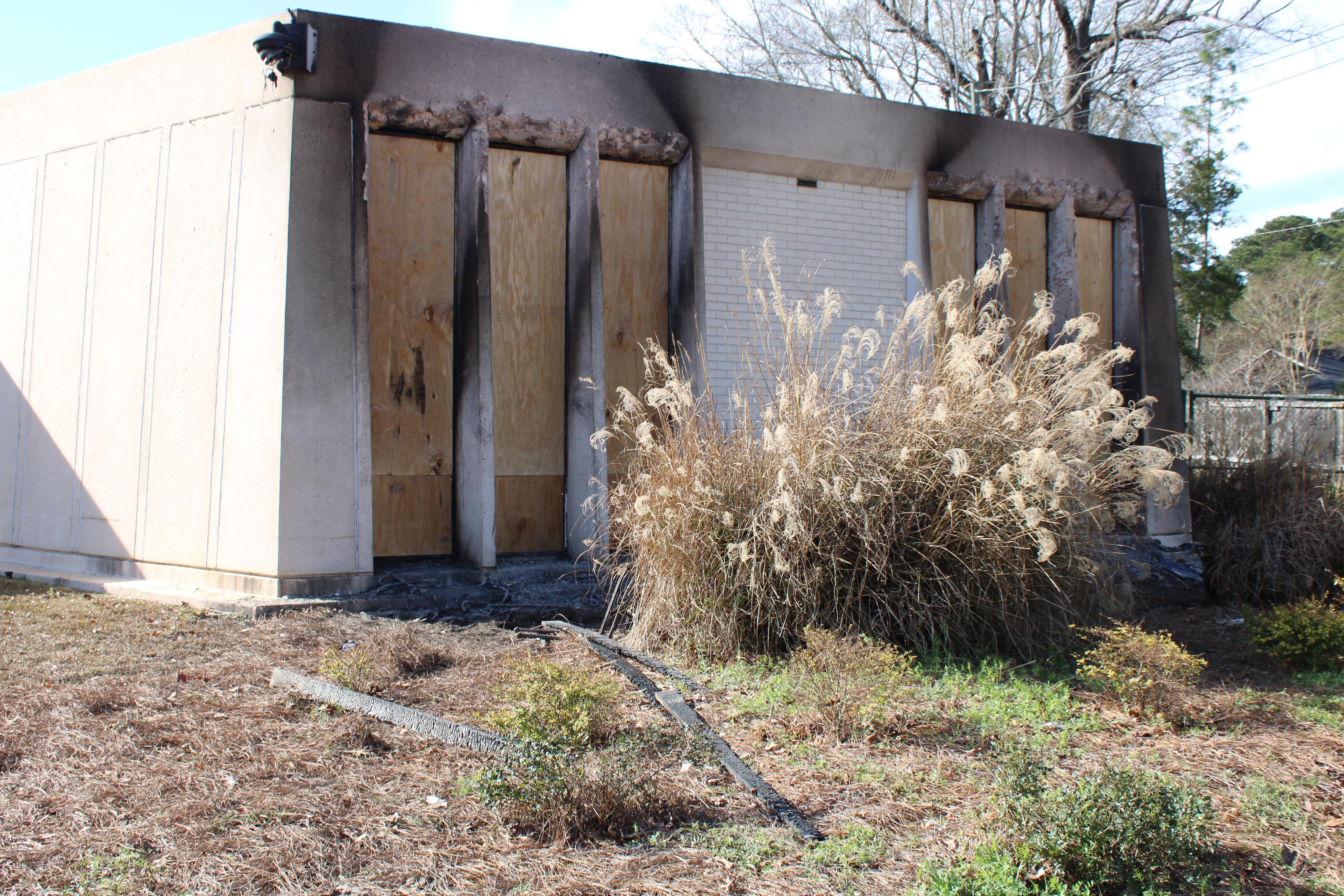 Plywood covers the windows of Beth Israel's library after glass was blown out by fire.