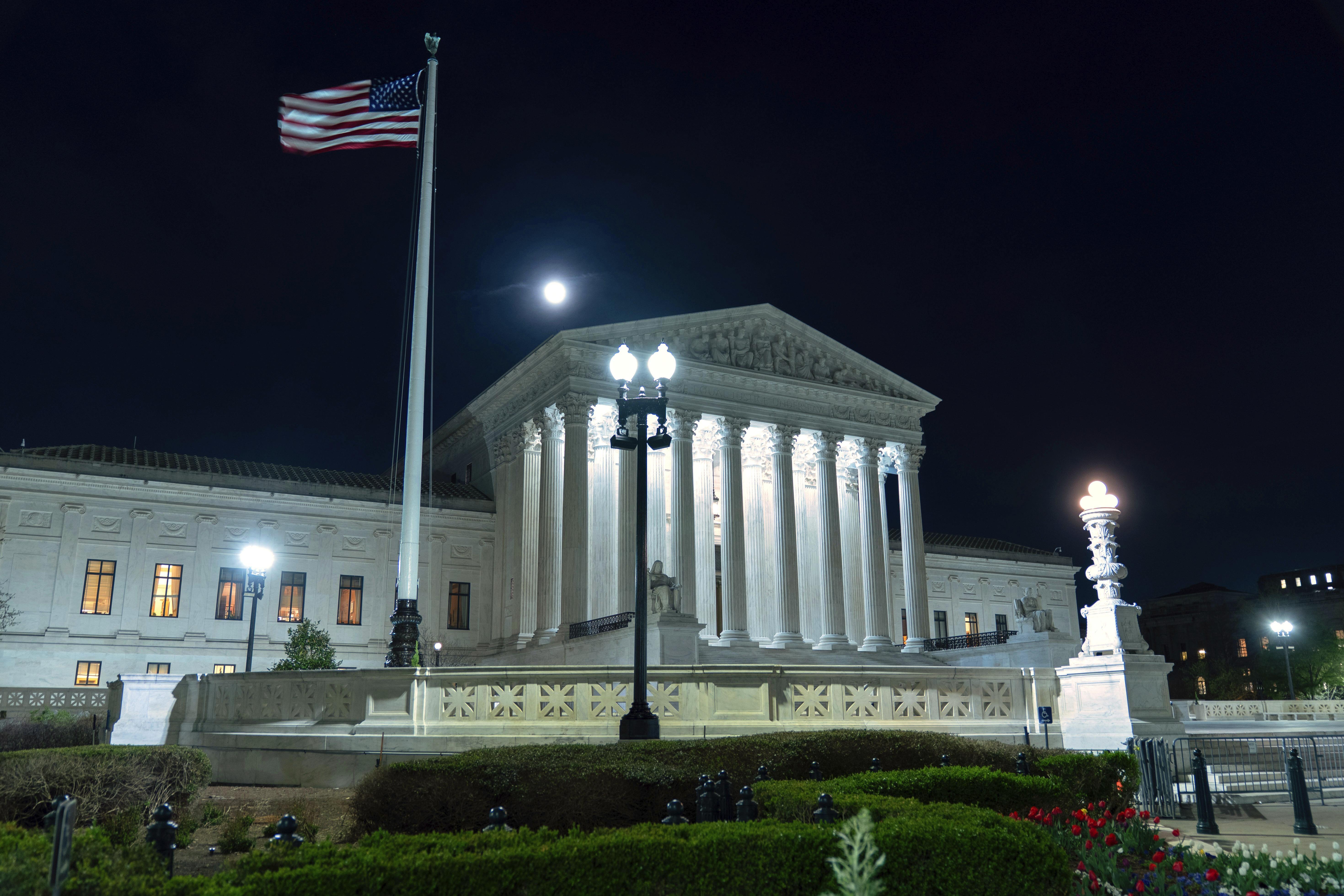 The U.S. Supreme Court is seen as the moon rises Tuesday, March 31, 2026, in Washington.