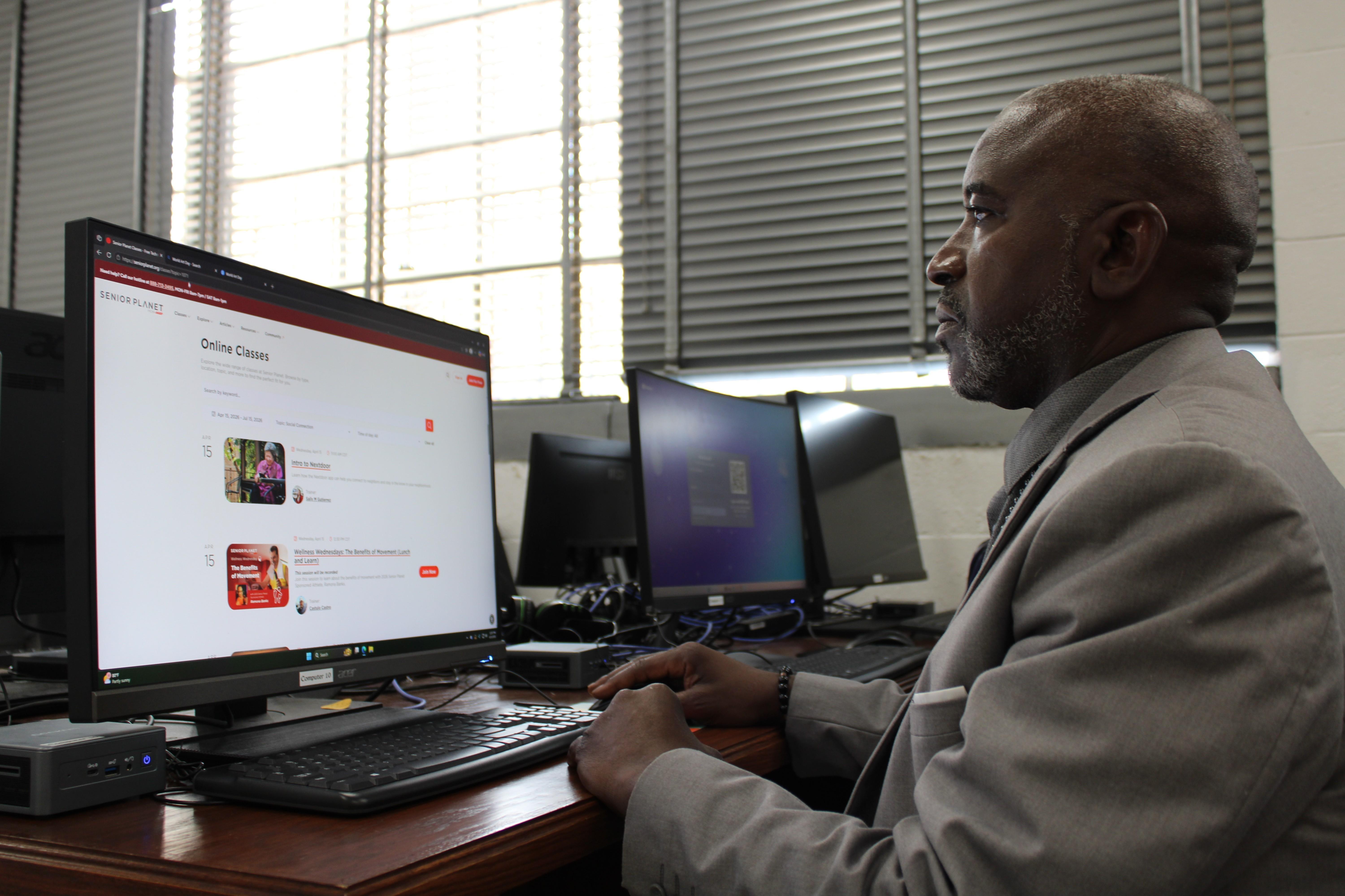 J.C. Johnson looks over the webpage for Senior Planet, a tech curriculum designed for older adults by the AARP.