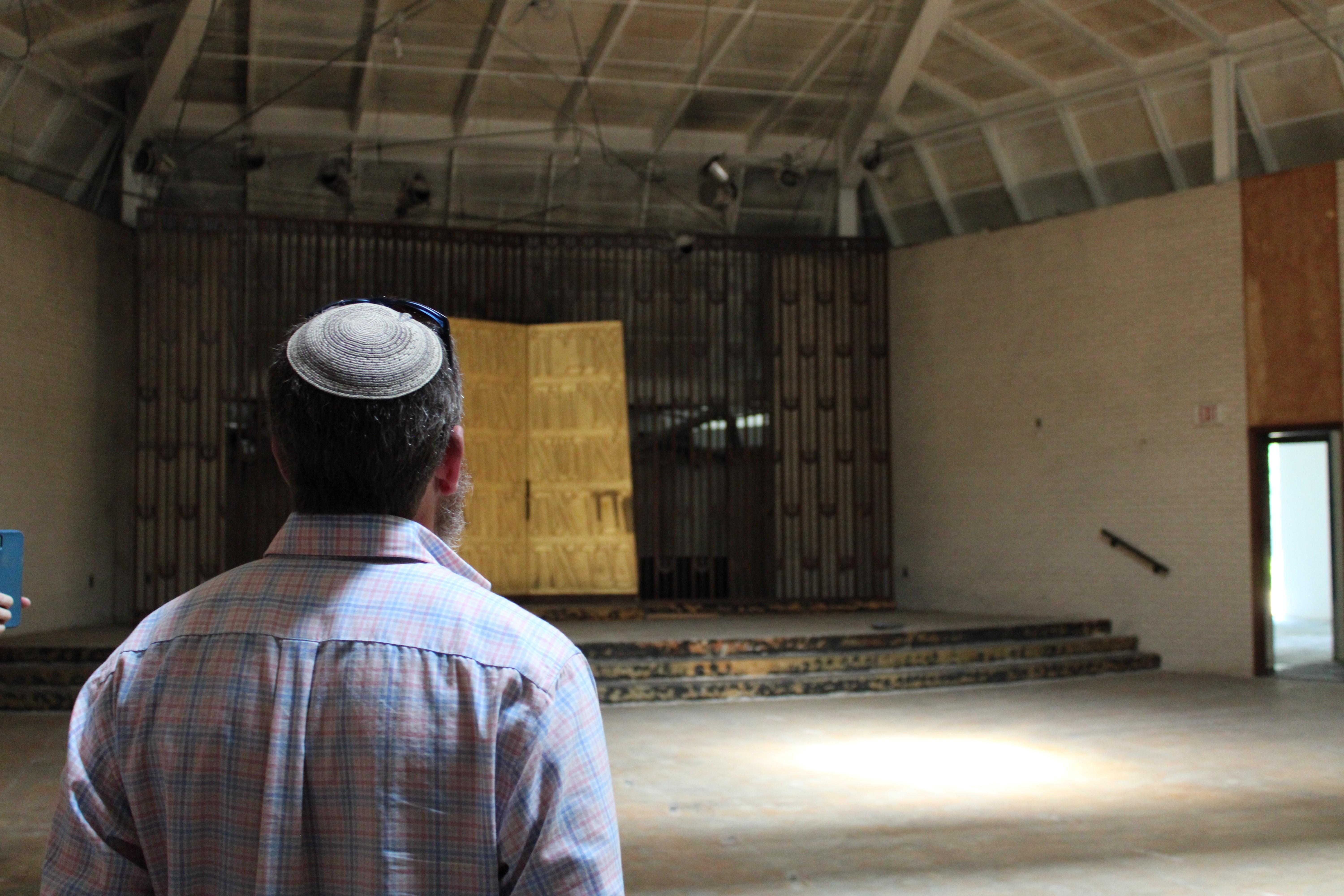 Congregation president Zach Shemper looks at the synagogue's ark in its main sanctuary April 26, 2026.