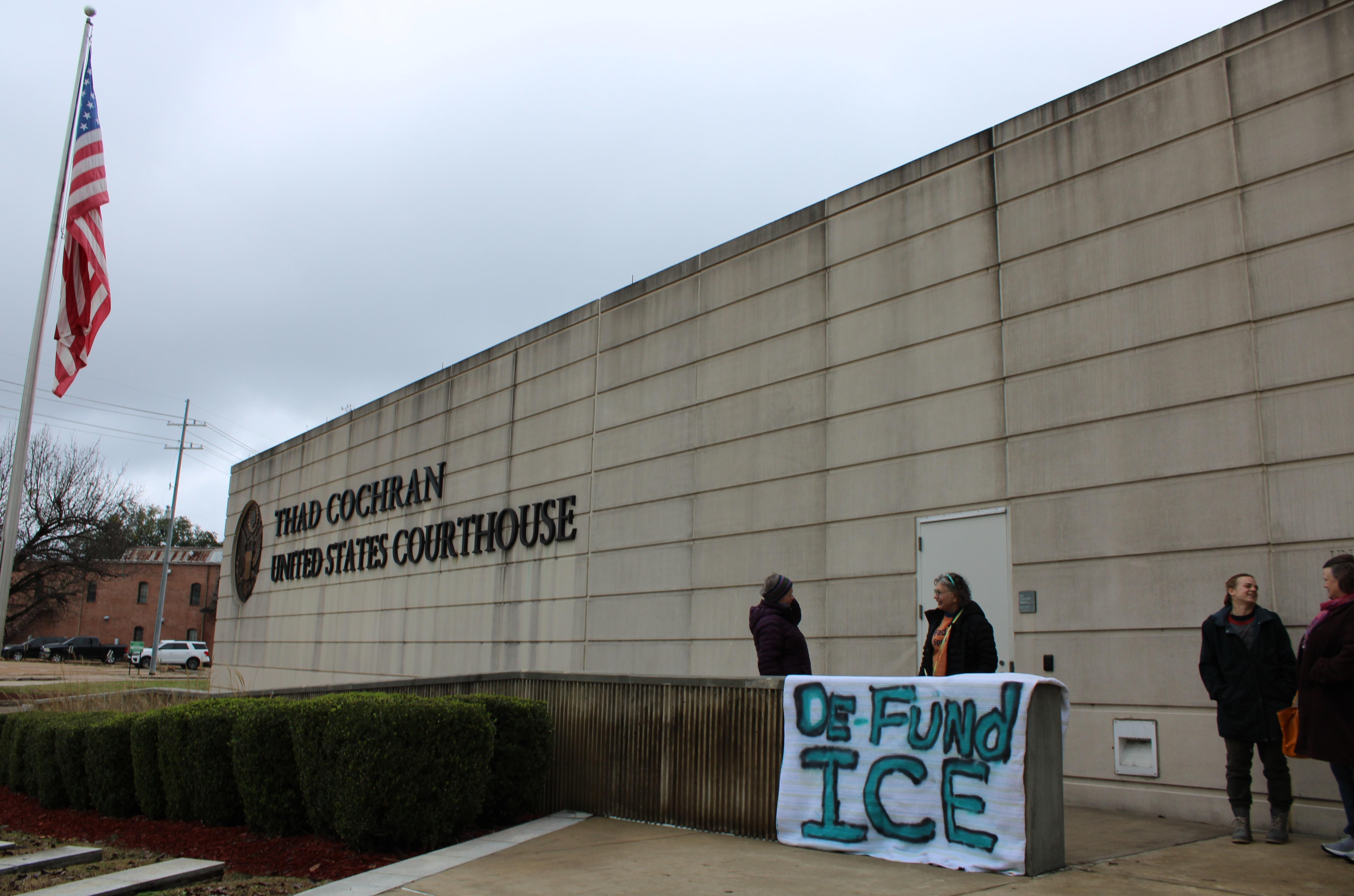 Activists hung banners critical of ICE outside of the federal courthouse in Jackson January 24, 2026, including one that reads "De-fund ICE."