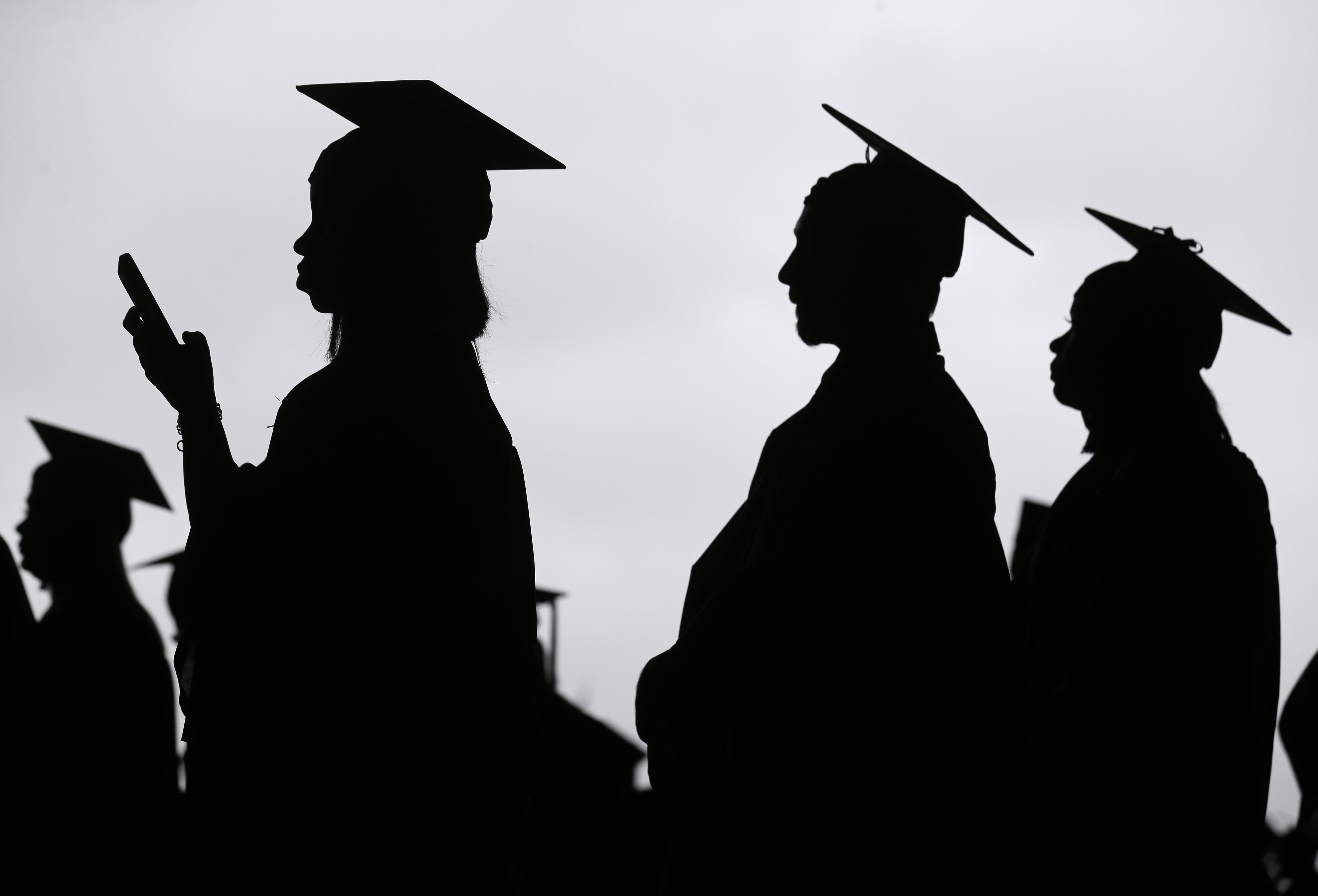 In this May 17, 2018, file photo, new graduates line up before the start of the Bergen Community College commencement at MetLife Stadium in East Rutherford, N.J. 