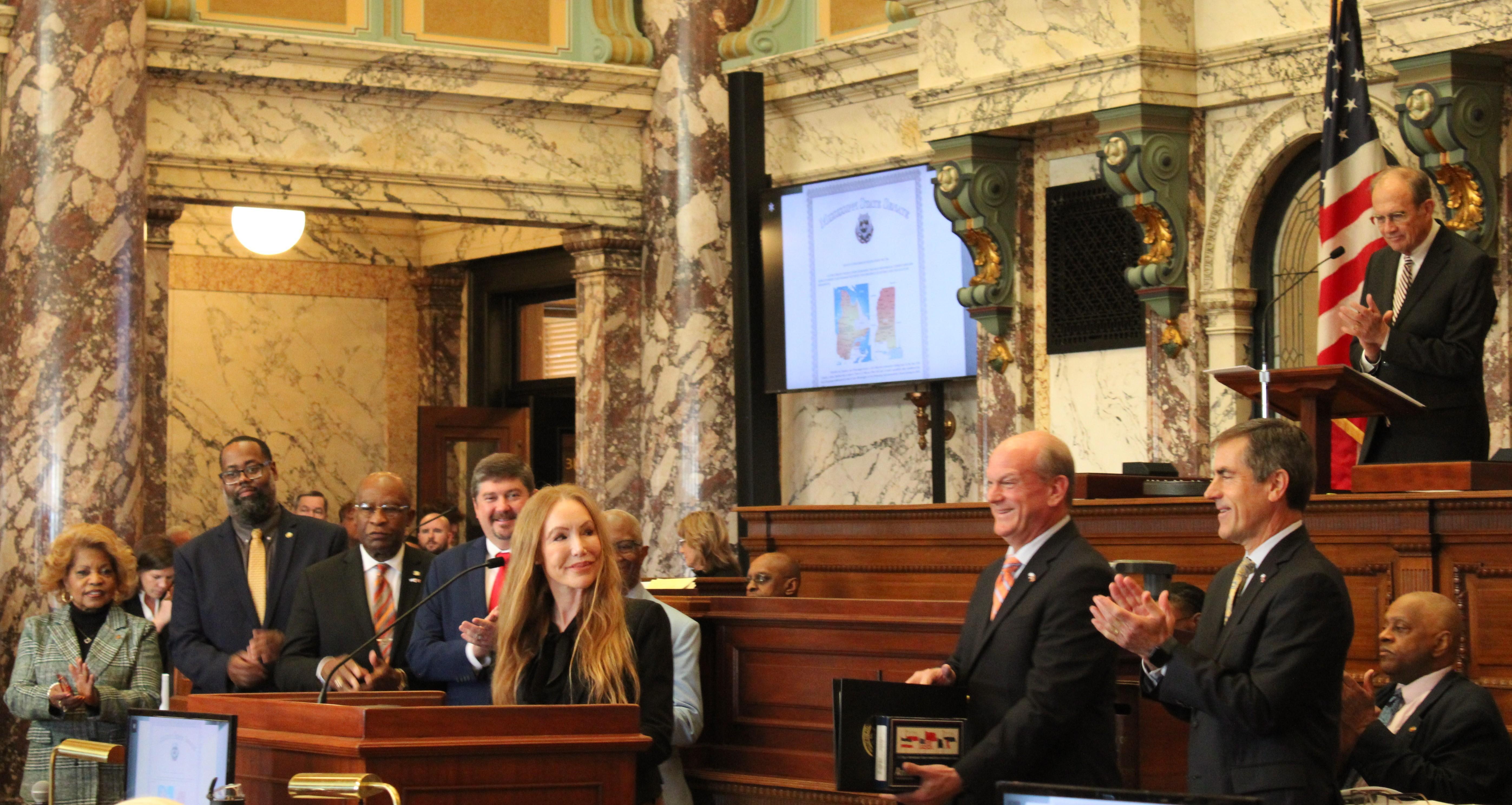 Québec's southeastern representative, Nathalie Rivard, smiles as Sen. Wiggins presents the resolution. 