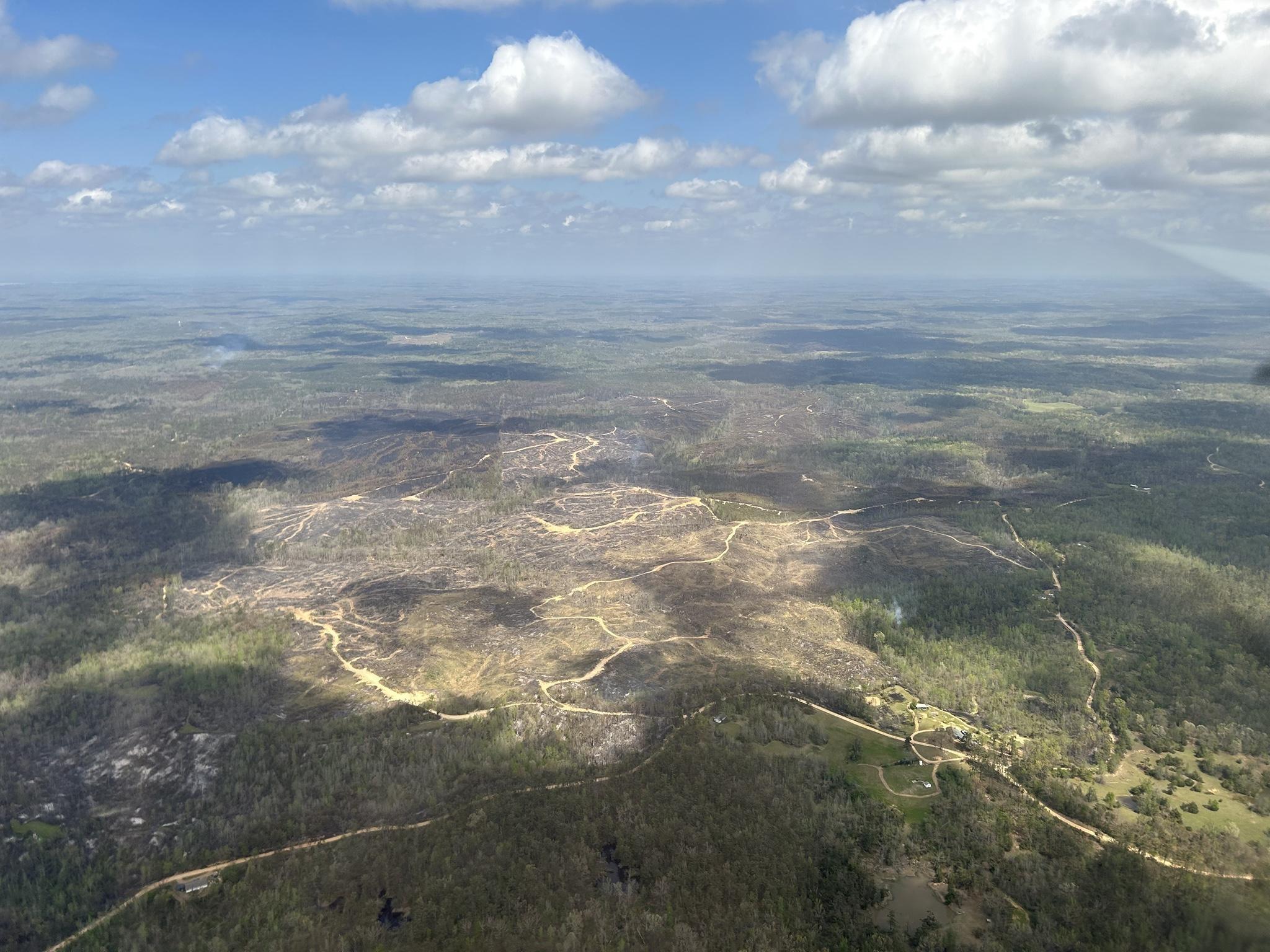 Light smoke is seen rising from patches of scorched earth around Carroll County.