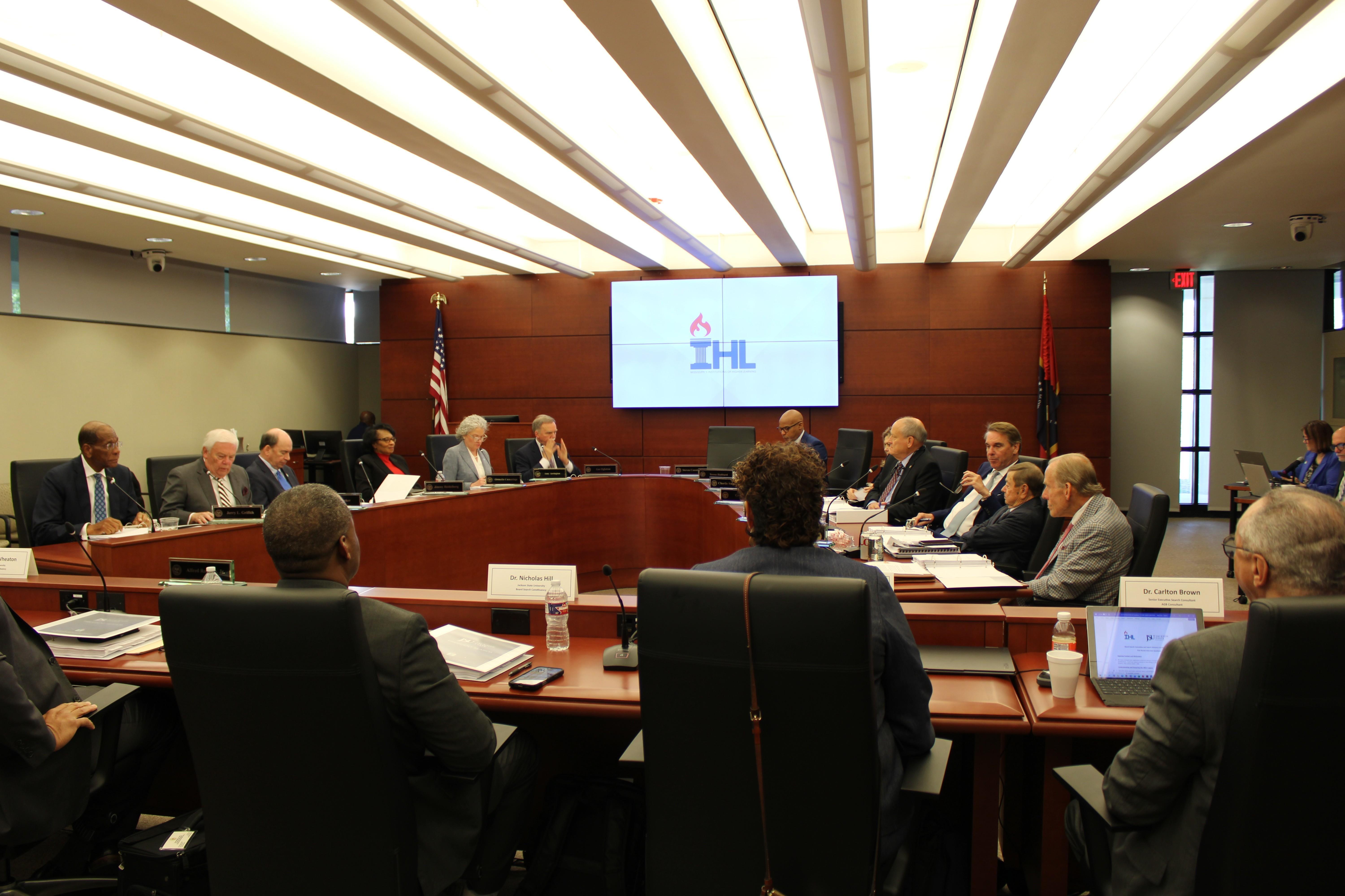 Members of the search committee and IHL's board prepare to enter into executive session.