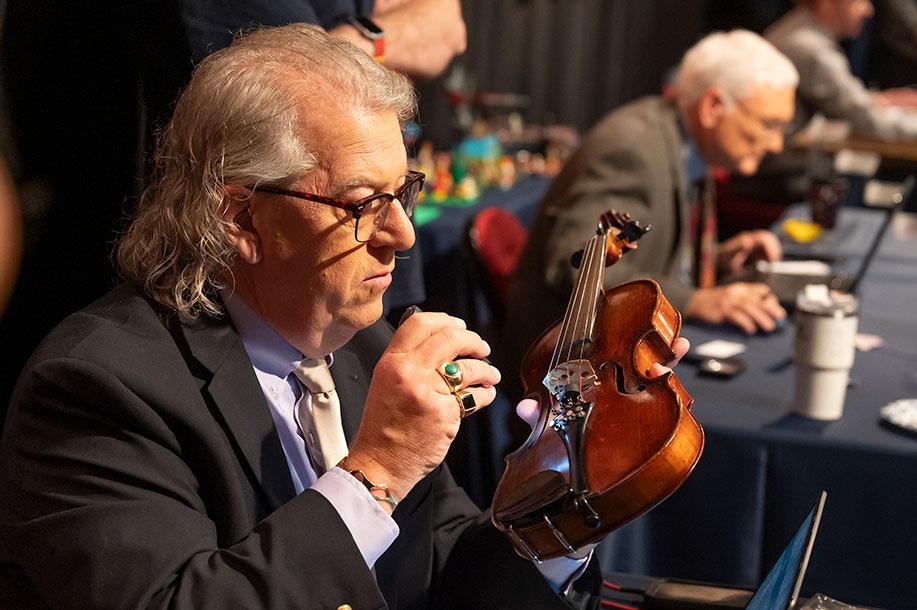 Lead appraiser Amory LeCuyer examines a violin