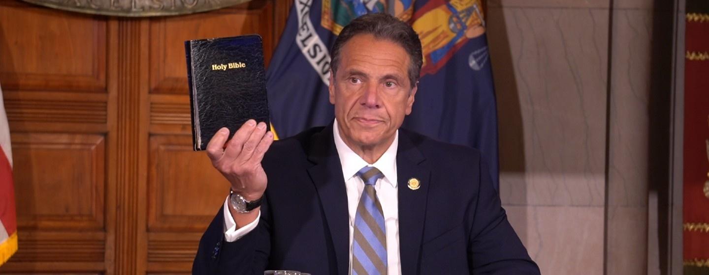 Gov. Andrew Cuomo holds up a bible at his daily press briefing