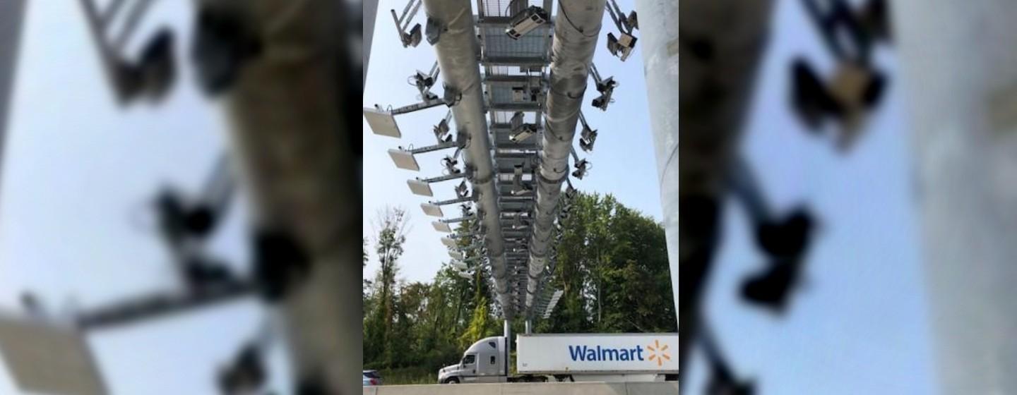 Automatic toll readers over the highway with a Walmart truck underneath