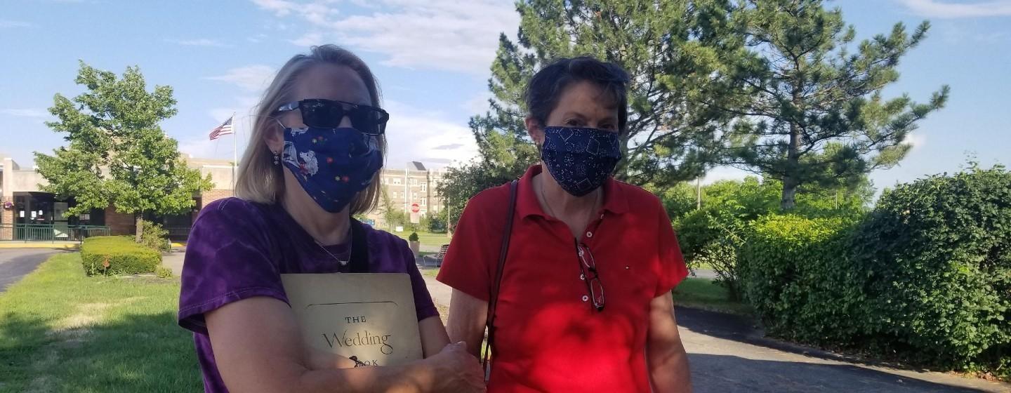 Sisters Anne Kuczkowski and Mary Lou Plesac stand side by side with face masks on