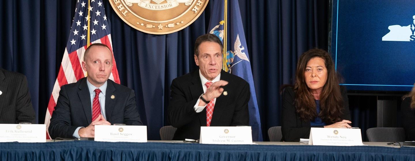 Gov. Andrew Cuomo Speaking to a crown from a panel