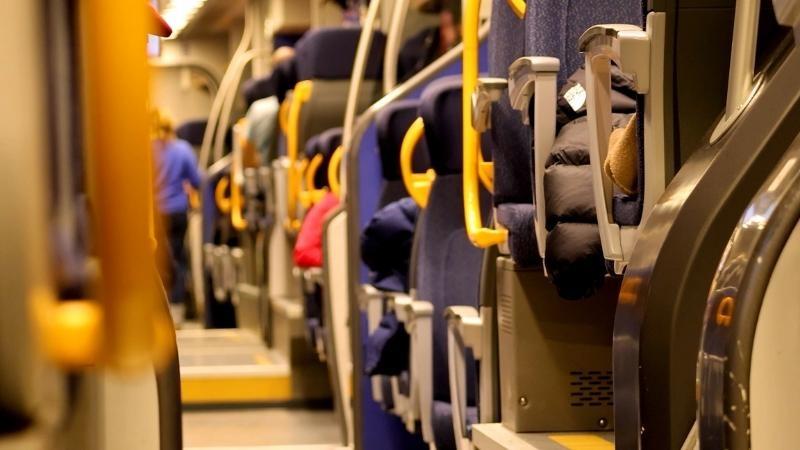 Passengers ride a regional train in northern Italy, which is required for spectators, workers and organizers as events are spread across multiple host cities during the Milan–Cortina 2026 Winter Olympics.