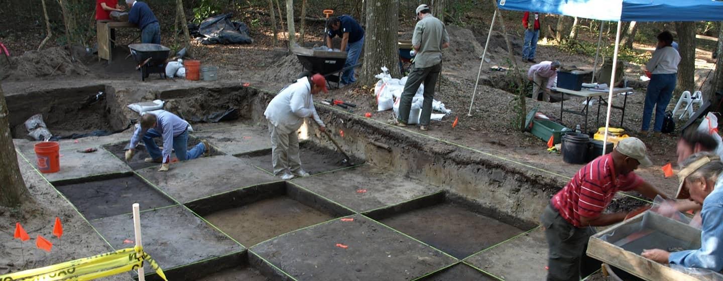 group excavating in woods with poured concrete