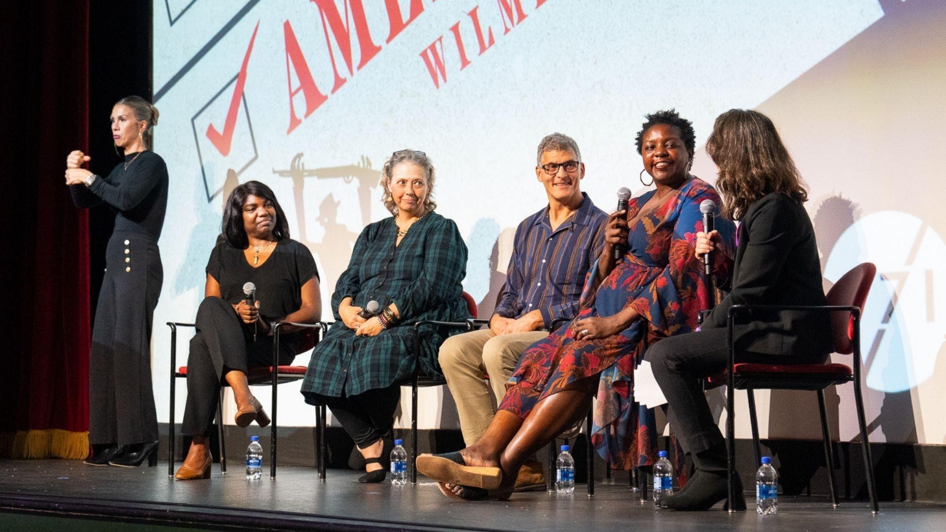 Panelists and filmmakers on stage at the "American Coup: Wilmington 1898" screening event at Thalian Hall Center for the Performing Arts in Wilmington, NC.