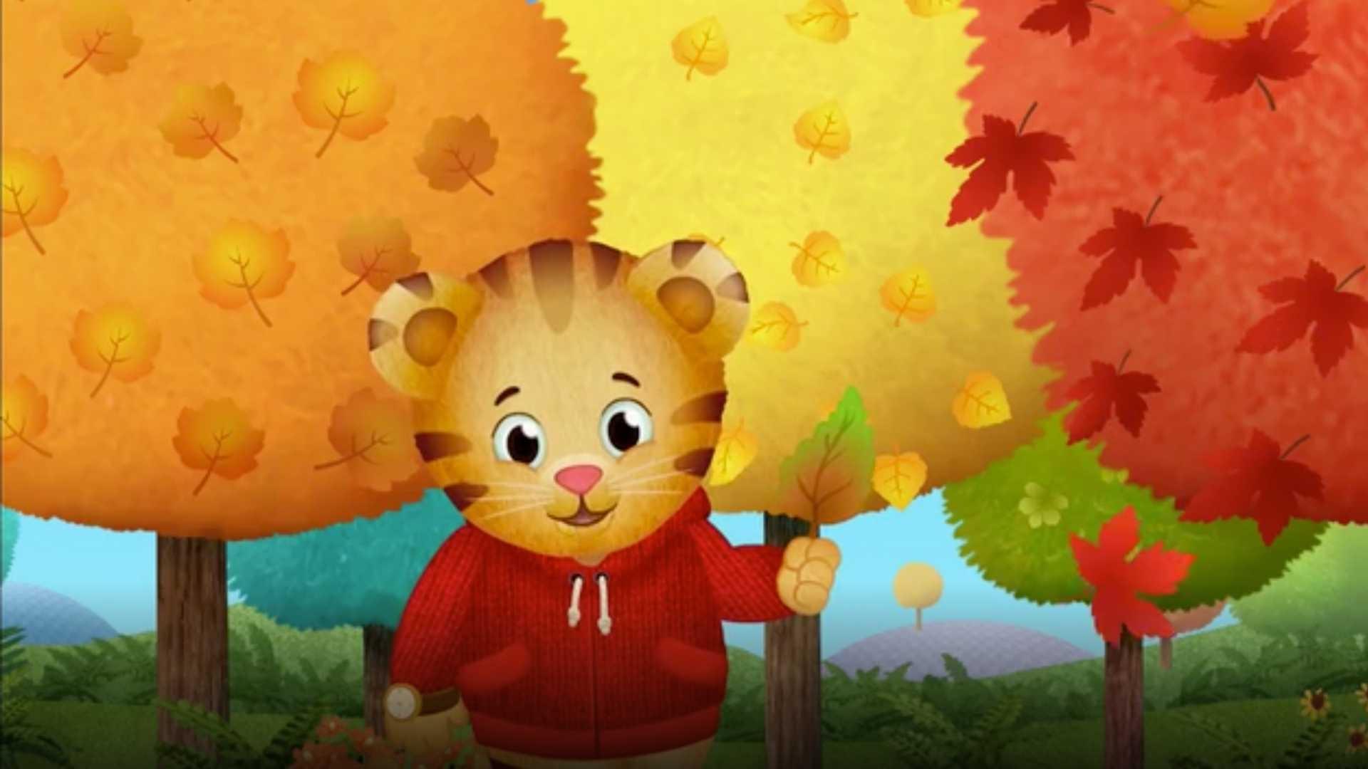 Daniel Tiger with autumn trees in the background
