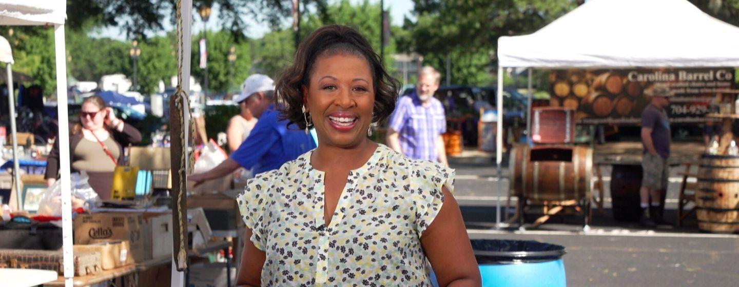 Deborah Holt Noel, host of NC Weekend in front of an outdoor market.