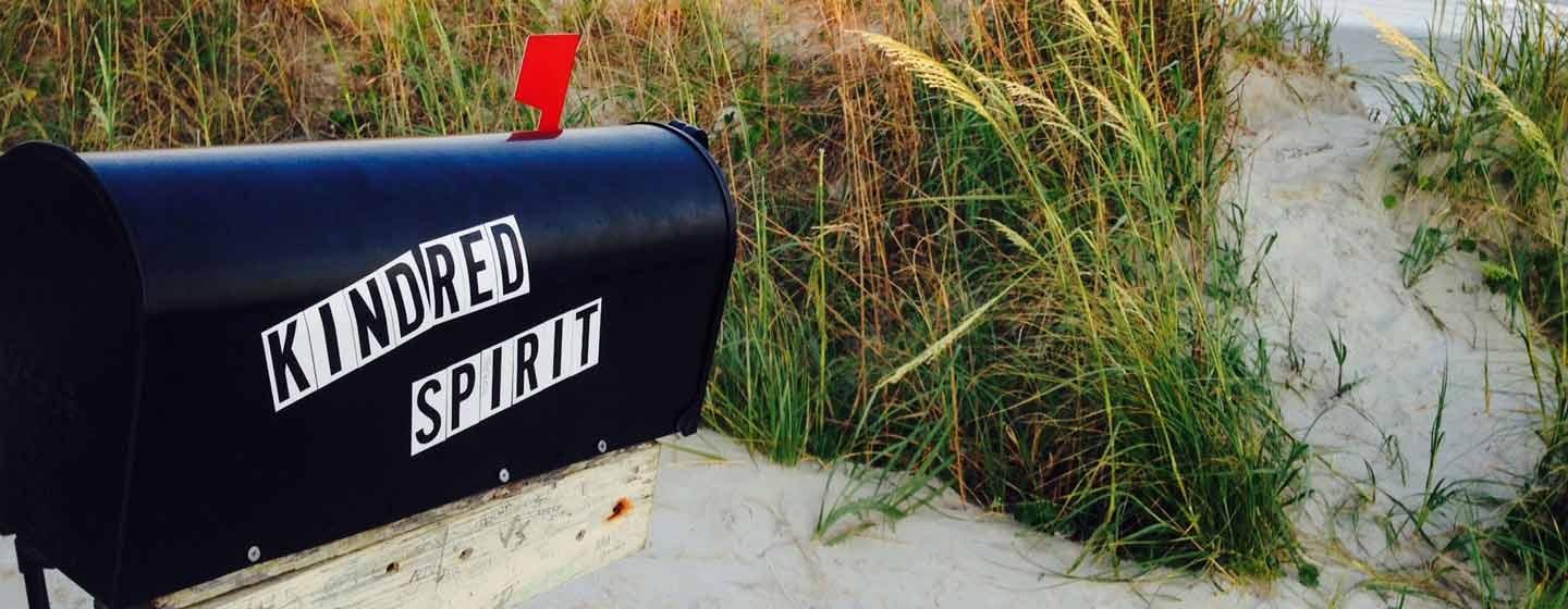 sand and sea grass with mailbox with words KINDRED SPIRIT on the side