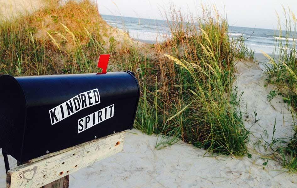 sand and sea grass with mailbox with words KINDRED SPIRIT on the side