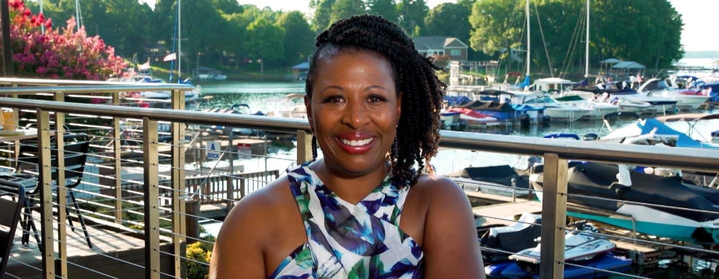 Deborah Holt Noel sitting at a restaurant in front of a marina.